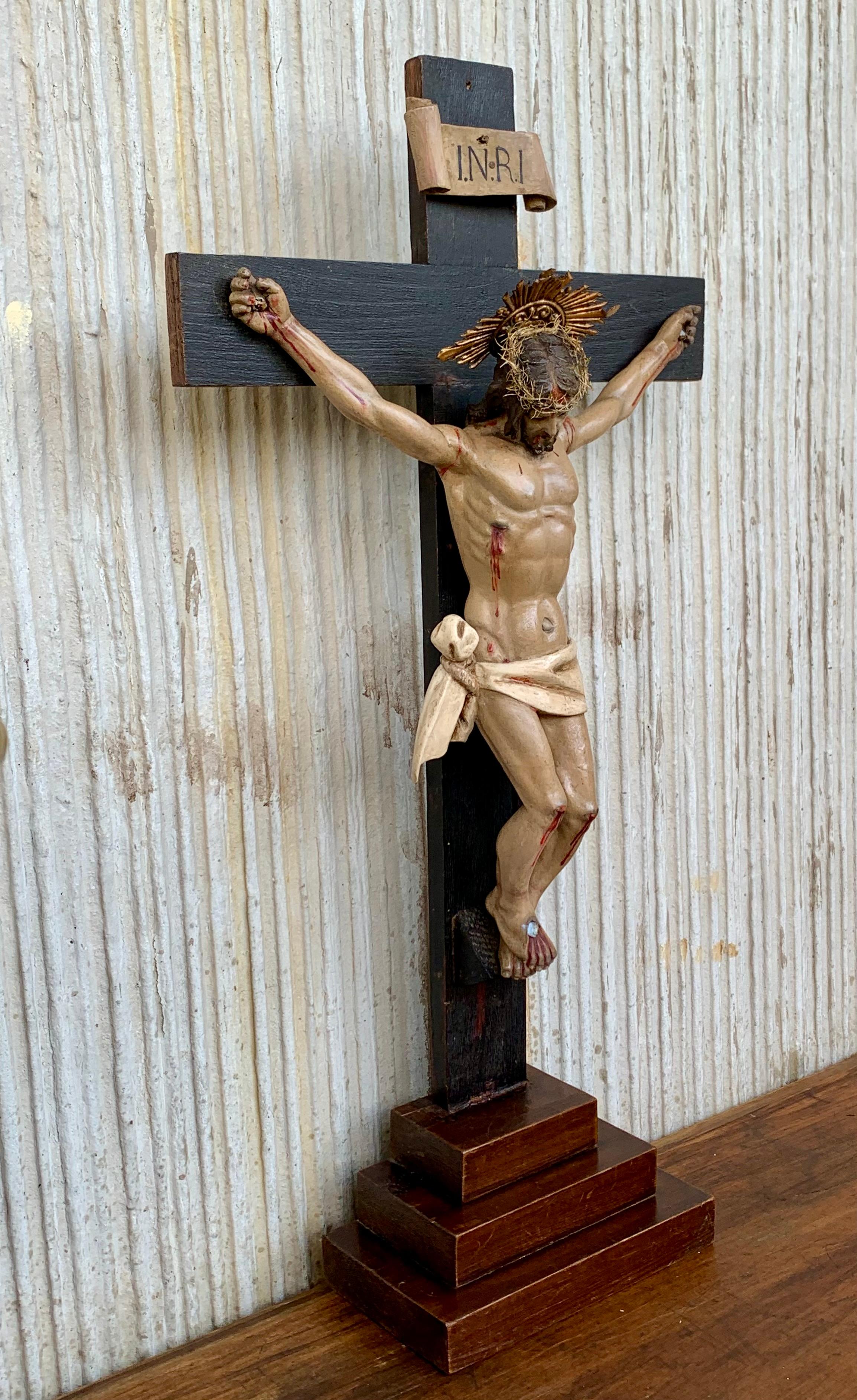 Crucifix from the mid-1800s with a carved shroud or veil depicting Christ in the base. This unique and remarkable antique crucifix can both be used as a table and as a wall crucifix. Over the decades we have sold a number of unique and very well