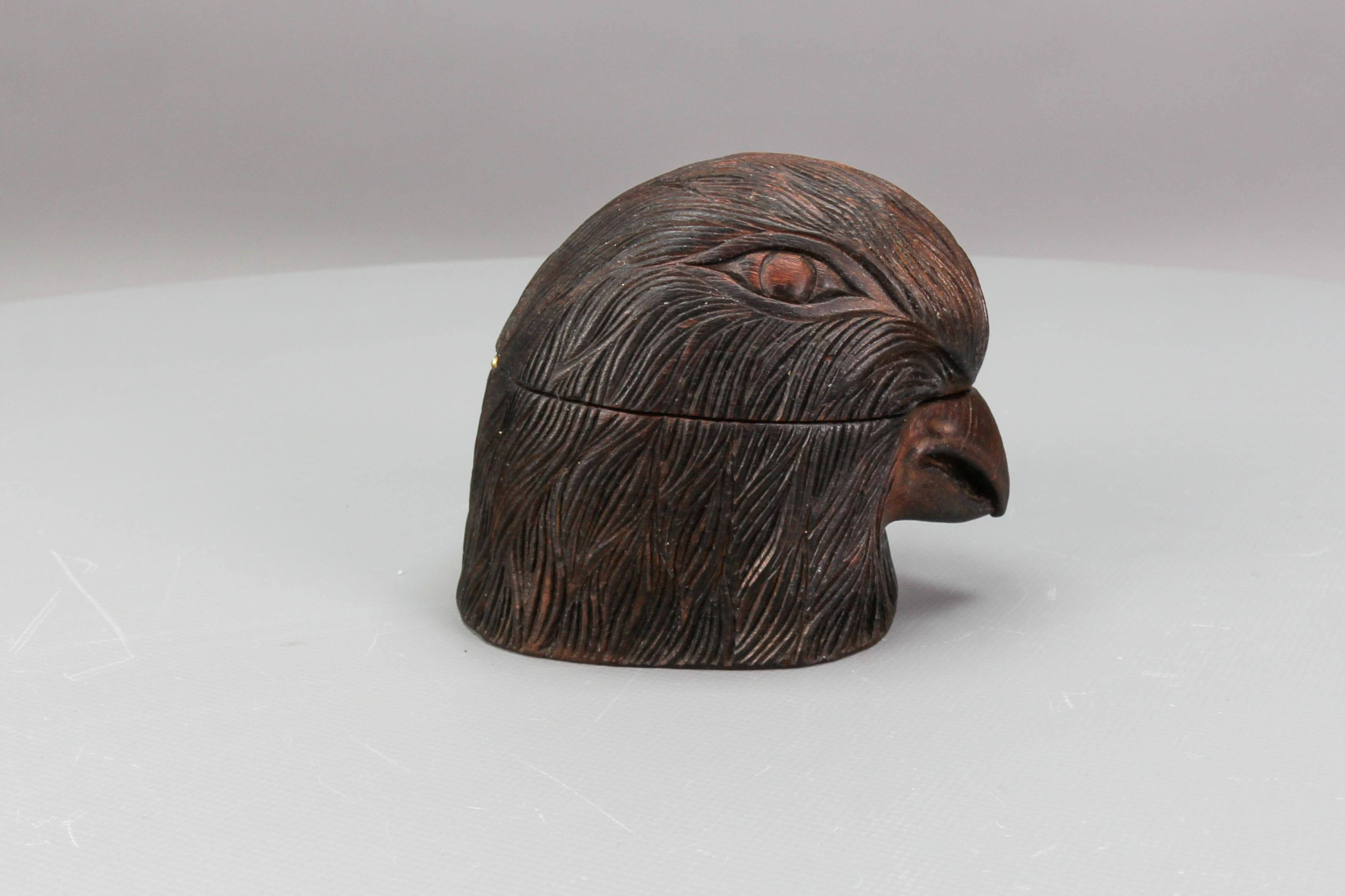 An Art Deco hand-carved wooden figural humidor in the shape of a bird head, circa the 1930s.
This adorable, dark brown, linden wood humidor or a small box is masterfully carved and features a detailed head of a bird. The bird's head can be opened