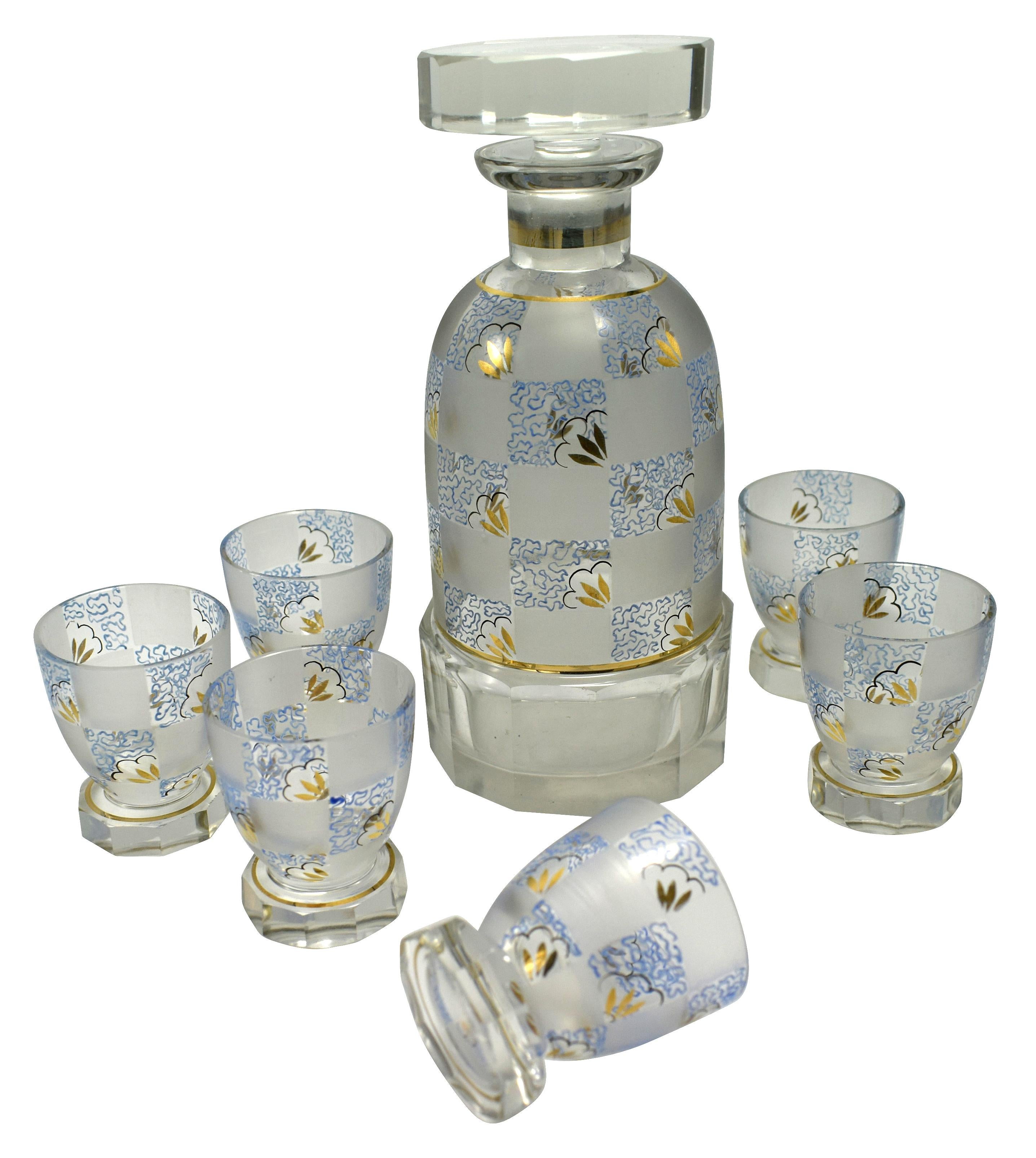 Very high quality 1930s Art Deco Czech glass decanter set. Features a Classic shape decanter with stopped and six shot sized glasses. The whole set is hand painted in beautiful soft tones of blue, black and gold enamel on a chequered background of