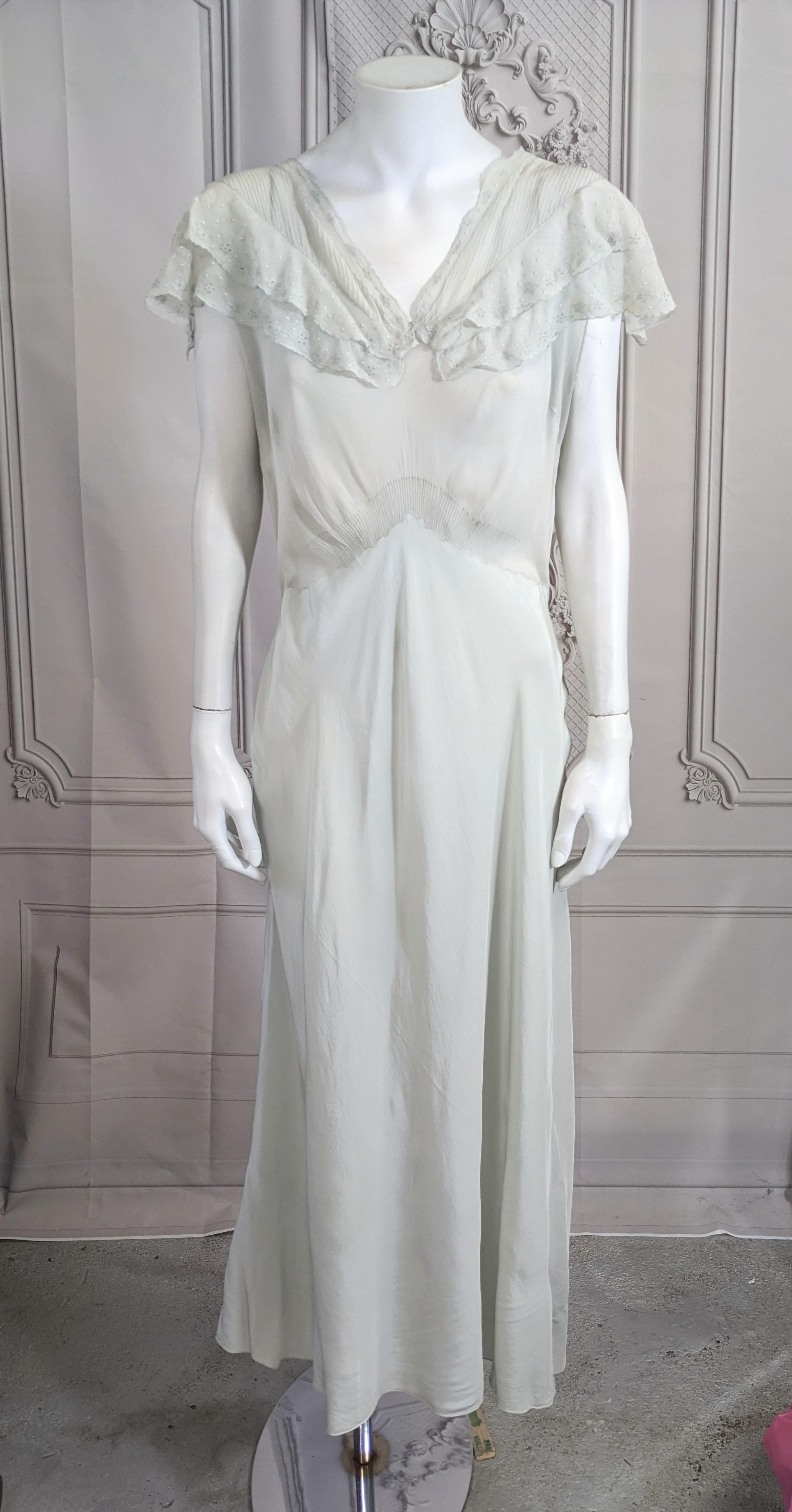 Lovely Art Deco Hand Embroidered Silk Chiffon and Crepe Slip Dress from the 1930's. Sheer chiffon bodice with double ruffle collar and wonderful hand embroidered florals throughout. Extraordinary tiny hand made mini tucks at collar and waist.
Silk