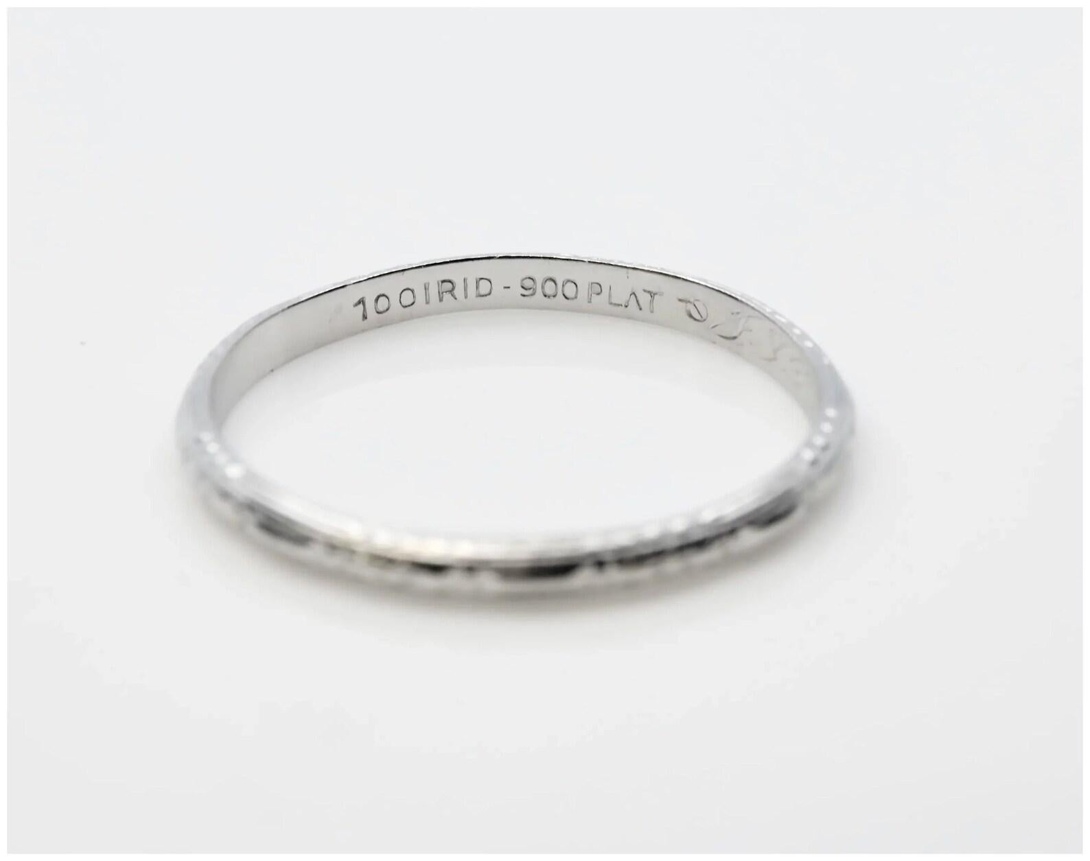 An original handmade Art Deco period platinum wedding band. In excellent condition, this circa 1932 platinum band measures 2mm wide and features beautiful hand engraving throughout.

This ring is a size 6 3/4, and should not be resized. Ring tests