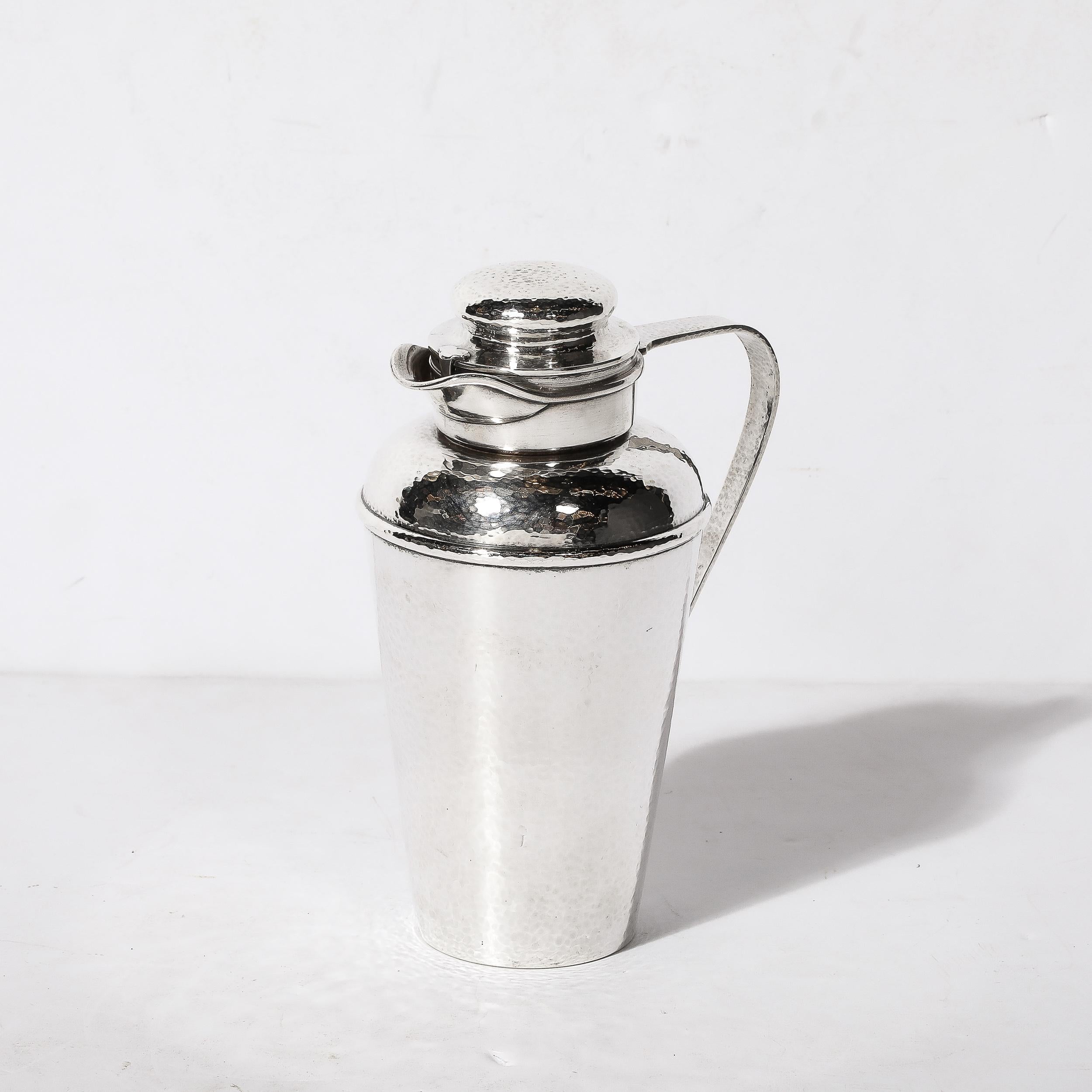 This brilliant Art Deco Hand-Hammered Sterling Silver Cocktail Shaker is by Gorham and originates from the United States, Circa 1925. Feautures hand-hammered textural detailing throughout the piece with an elegant minimal handle and tapered body,