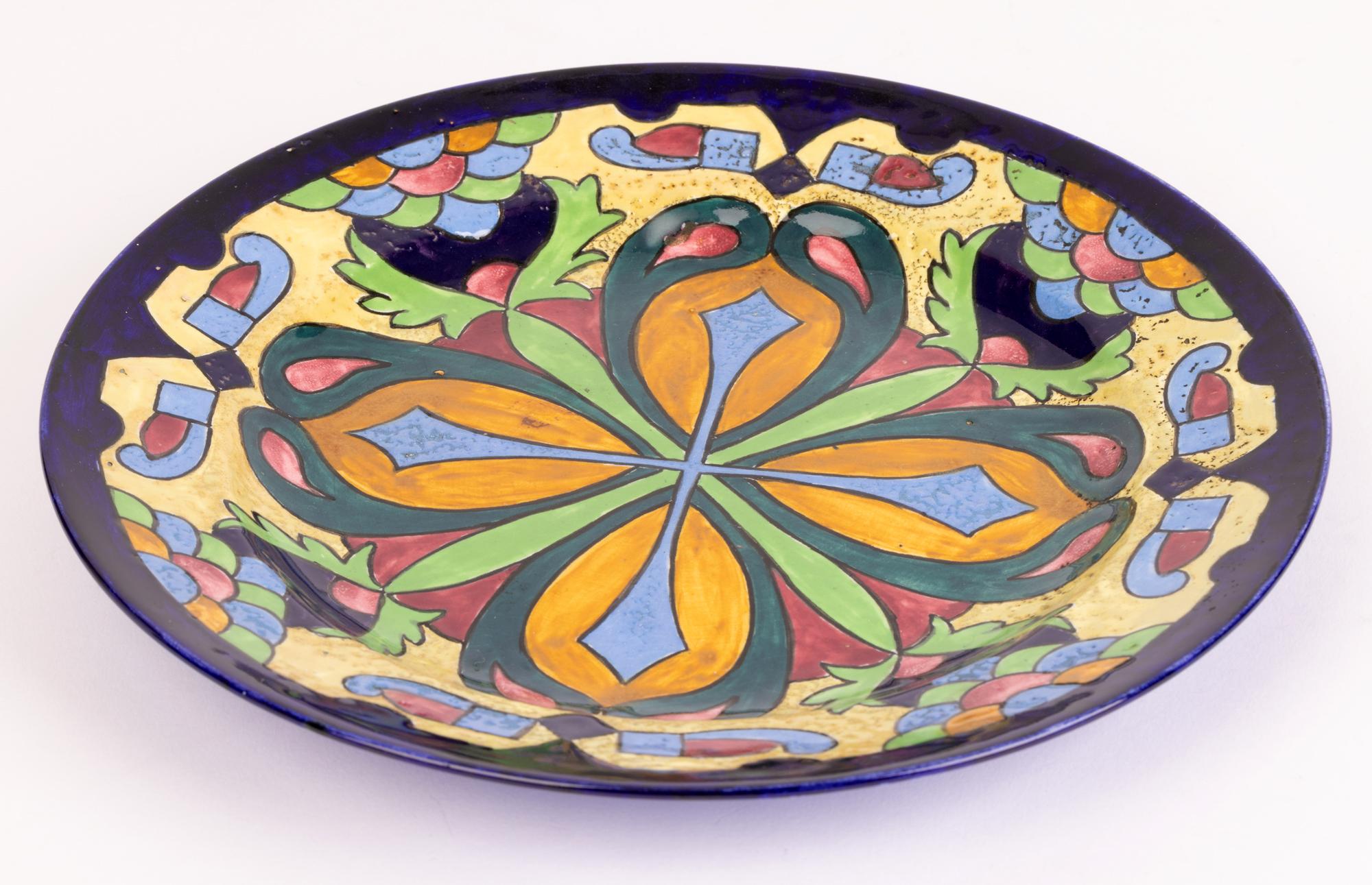 An unusual and unique English Art Deco hand painted pottery plate with an abstract leaf design attributed to renowned English ceramics designer Charlotte Rhead (English, 1885-1947) dated 1925. The plate we believe is a George Jones blank which may