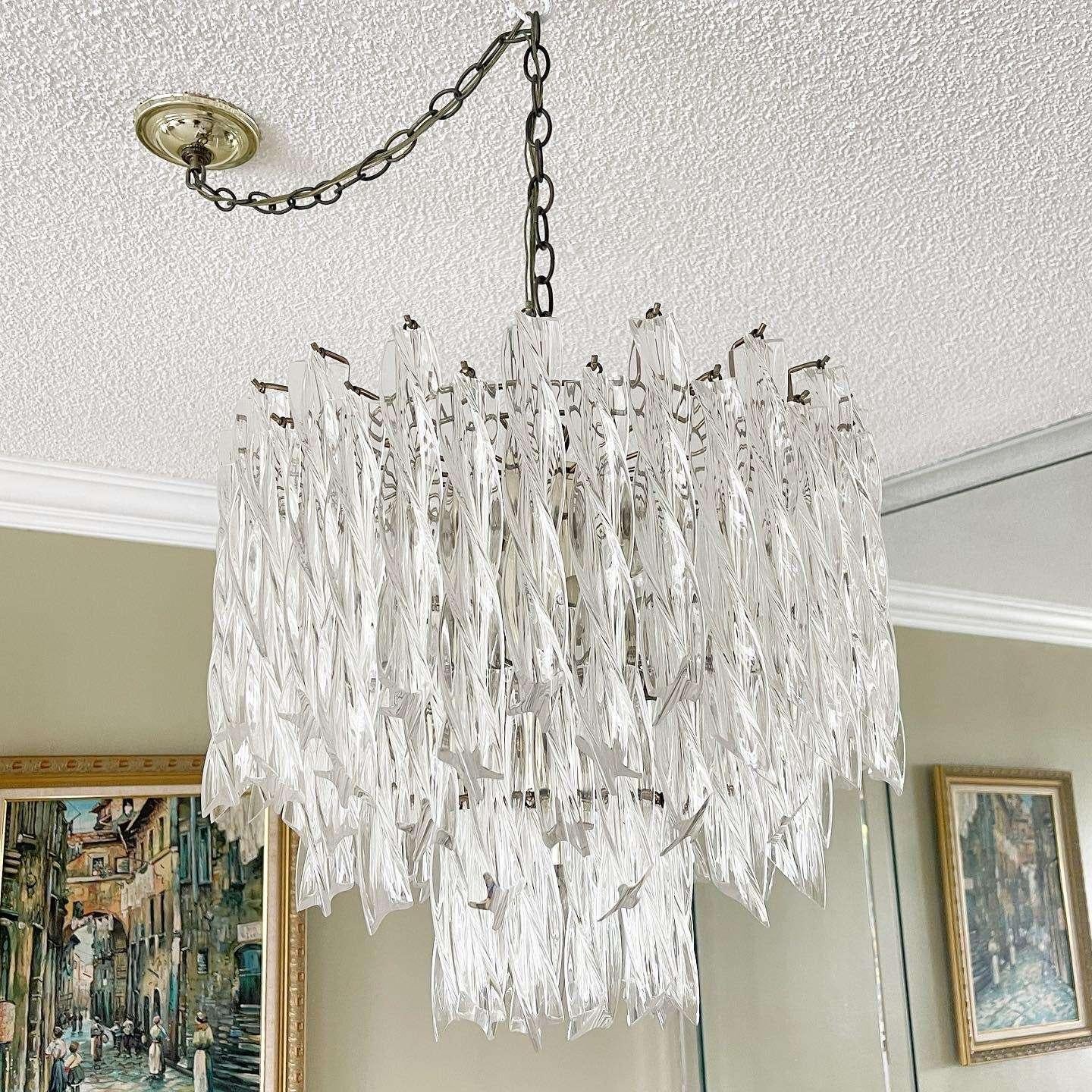 Exceptional vintage art deco revival lucite chandelier. Features a twisted lucite pendants hanging grime three tiers. Has 13 lights.
Chain length:
36”
