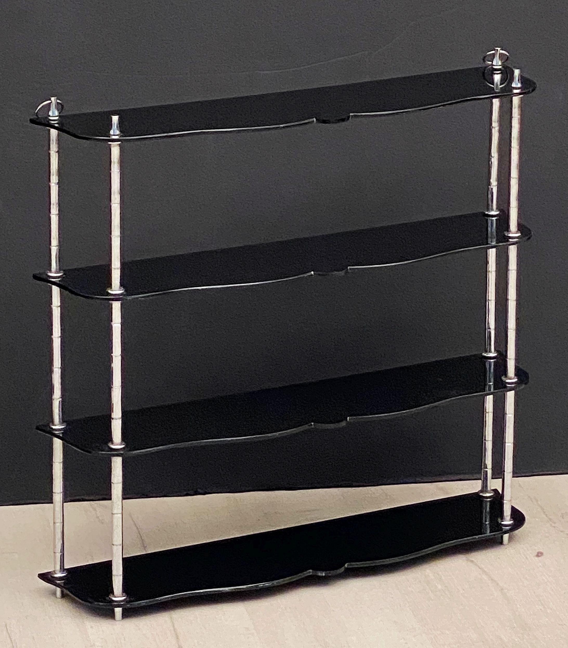 A handsome English hanging curio shelf from the Art Deco era, featuring stylish black Bakelite shelves and chrome supports.