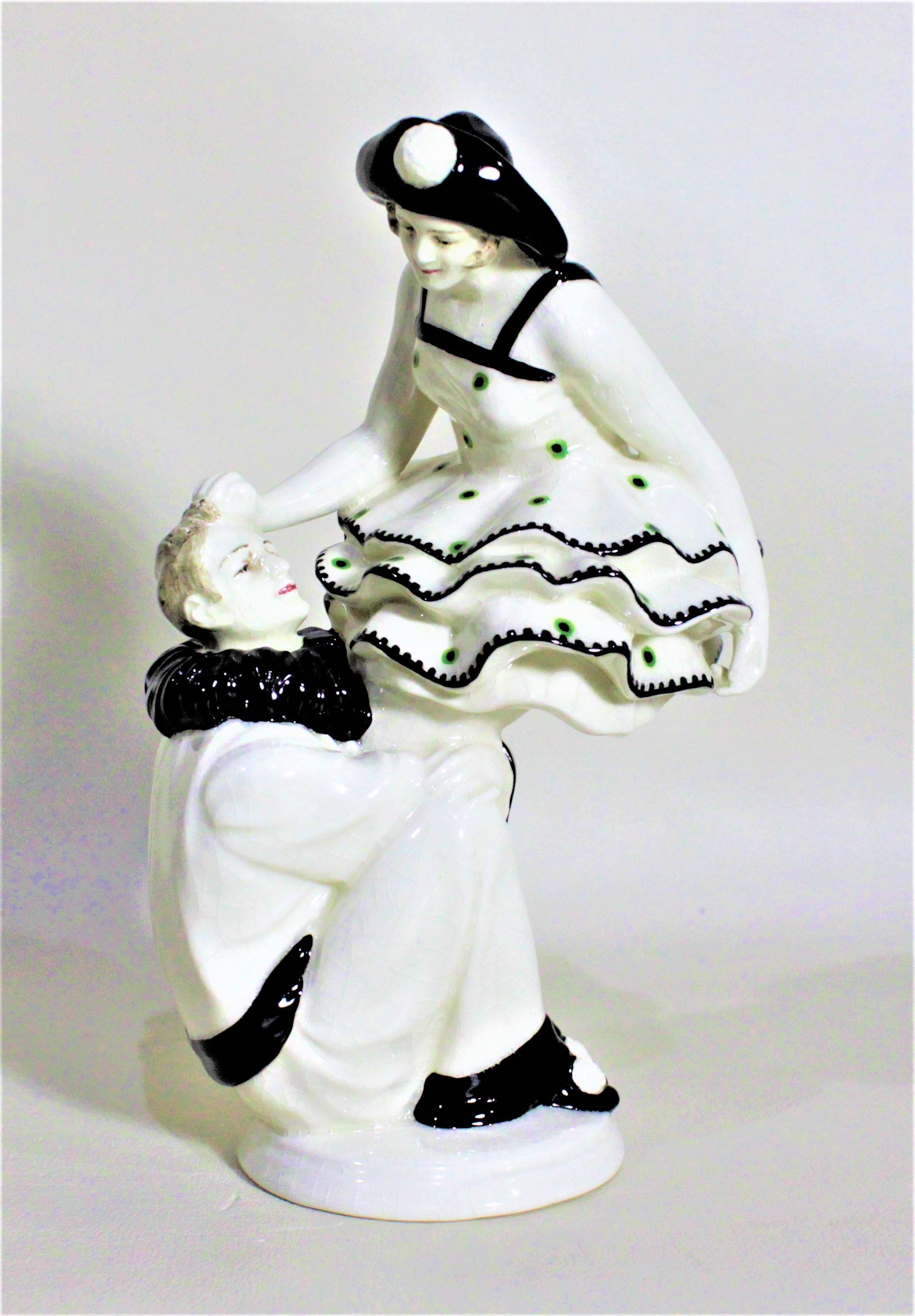 This Art Deco glazed earthenware figurine is unsigned and only numbered, but believed to have been made in either Germany or Austria in circa 1920. This figurine is done in a thick cream glaze with dramatic black accents. The figurine depicts a man