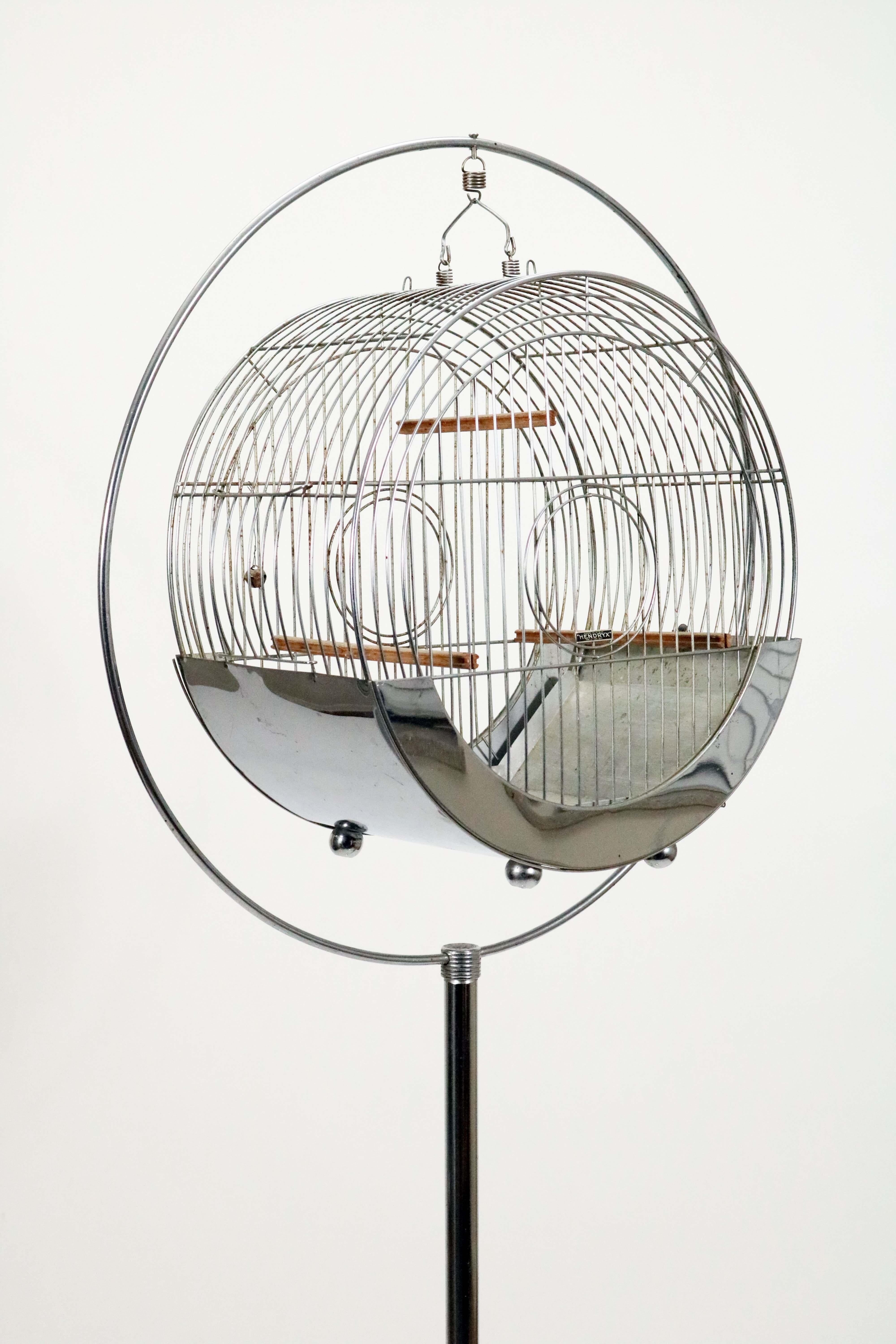 Beautiful Art Deco chrome bird cage and stand by Hendryx, circa 1930s. The cage separates from the stand so you can place on a table top. Even if you don't have a bird, this piece is a virtual piece of art!

Dimensions for the cage are 16.5
