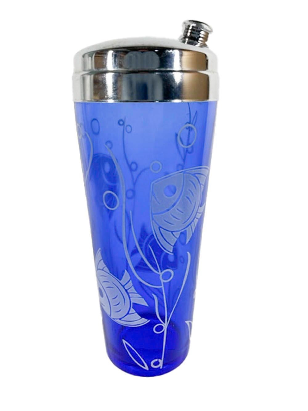 Art Deco, chrome lidded cobalt blue, cocktail shaker and four cocktail glasses with white tropical fish, bubbles and seaweed.
Shaker: 9