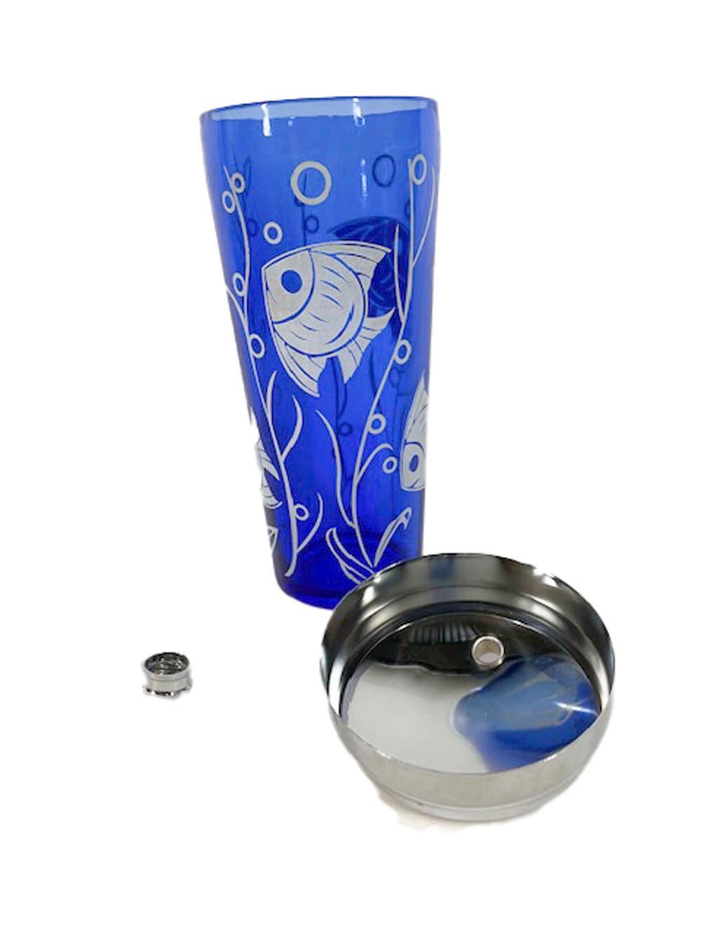 Art Deco cocktail shaker from the Hazel-Atlas Sportsman Series with a tropical fish motif in white on cobalt blue glass and having a chrome lid.