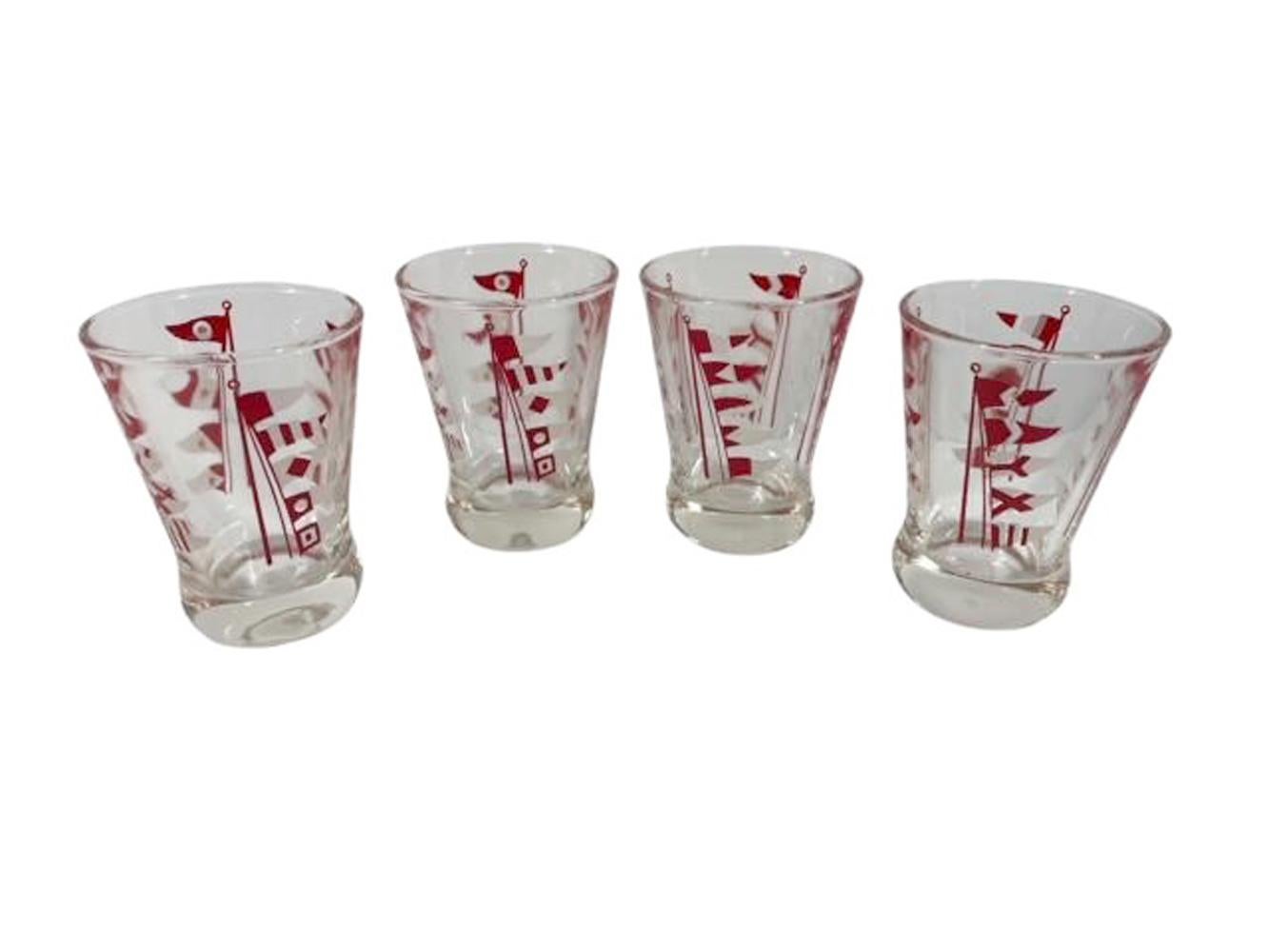 Art Deco cocktail shaker set by Hazel-Atlas, clear glass shaker with chrome top and four cocktail glasses all decorated with red and white nautical flags.
