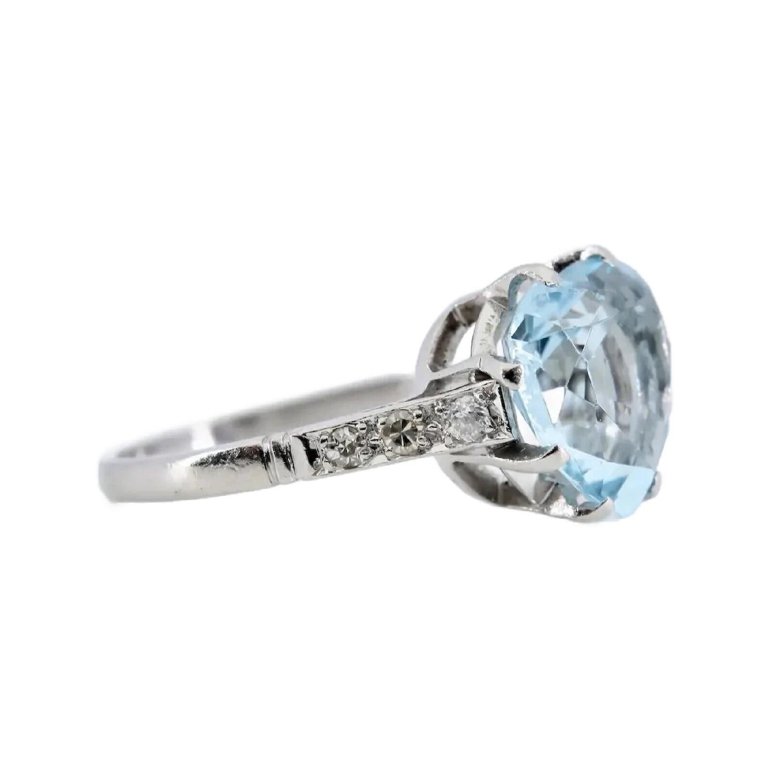 A handmade Art Deco period heart shaped aquamarine, and diamond ring in platinum.

Centered with a 3.10 Carat blue aquamarine set in a platinum basket mount.

Accented by six pave set old European cut diamonds of H color, SI1 clarity.

Tested as