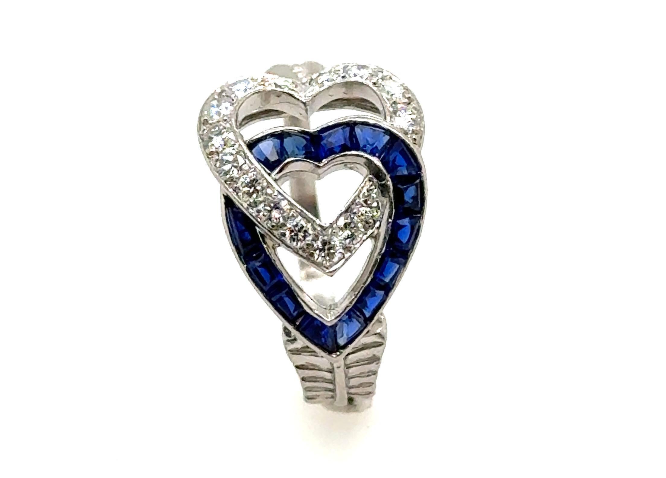 Genuine Original Art Deco Antique from 1930's Hearts and Arrow Sapphire Diamond Ring Platinum 


This Exquisite Ring Showcases a Captivating Royal Blue Sapphire Heart Elegantly Entwined with a Diamond Heart, Pierced by a Meticulously Hand Crafted