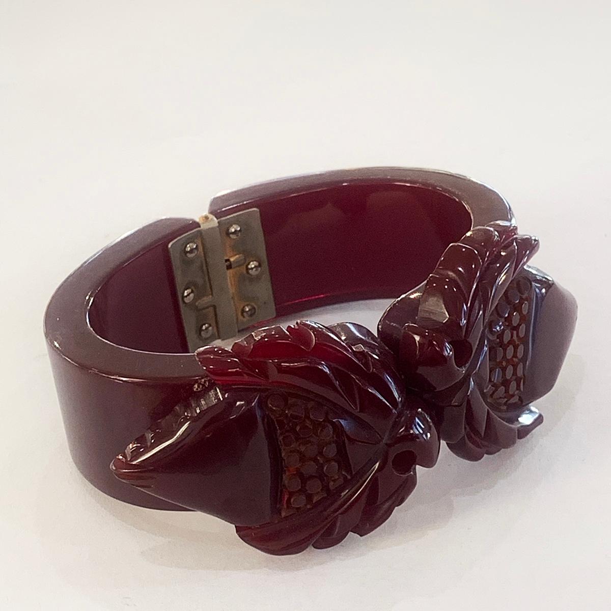 Women's or Men's Art Deco Heavily carved dark red bakelite hinged clamper bangle bracelet For Sale