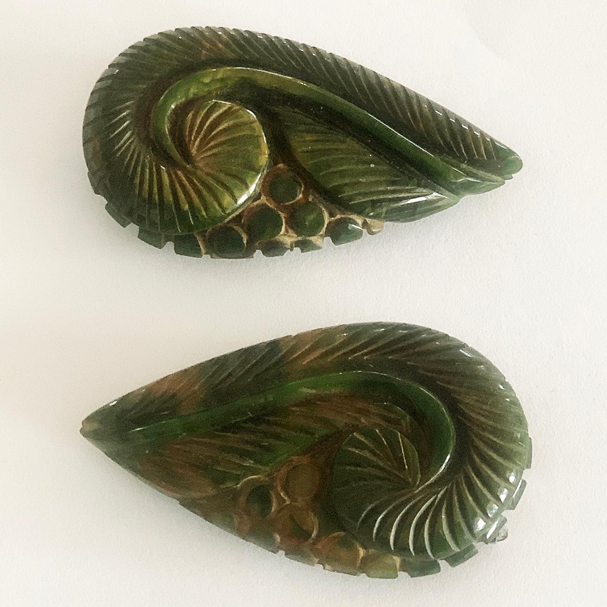 Art Deco Green Bakelite Fur or Dress Clips, in deeply Carved Green Bakelite in form of Fern Fronds and Berries, and softly stained with a yellow/orange patina to the engraved details. All in excellent condition, including the springs to rear of