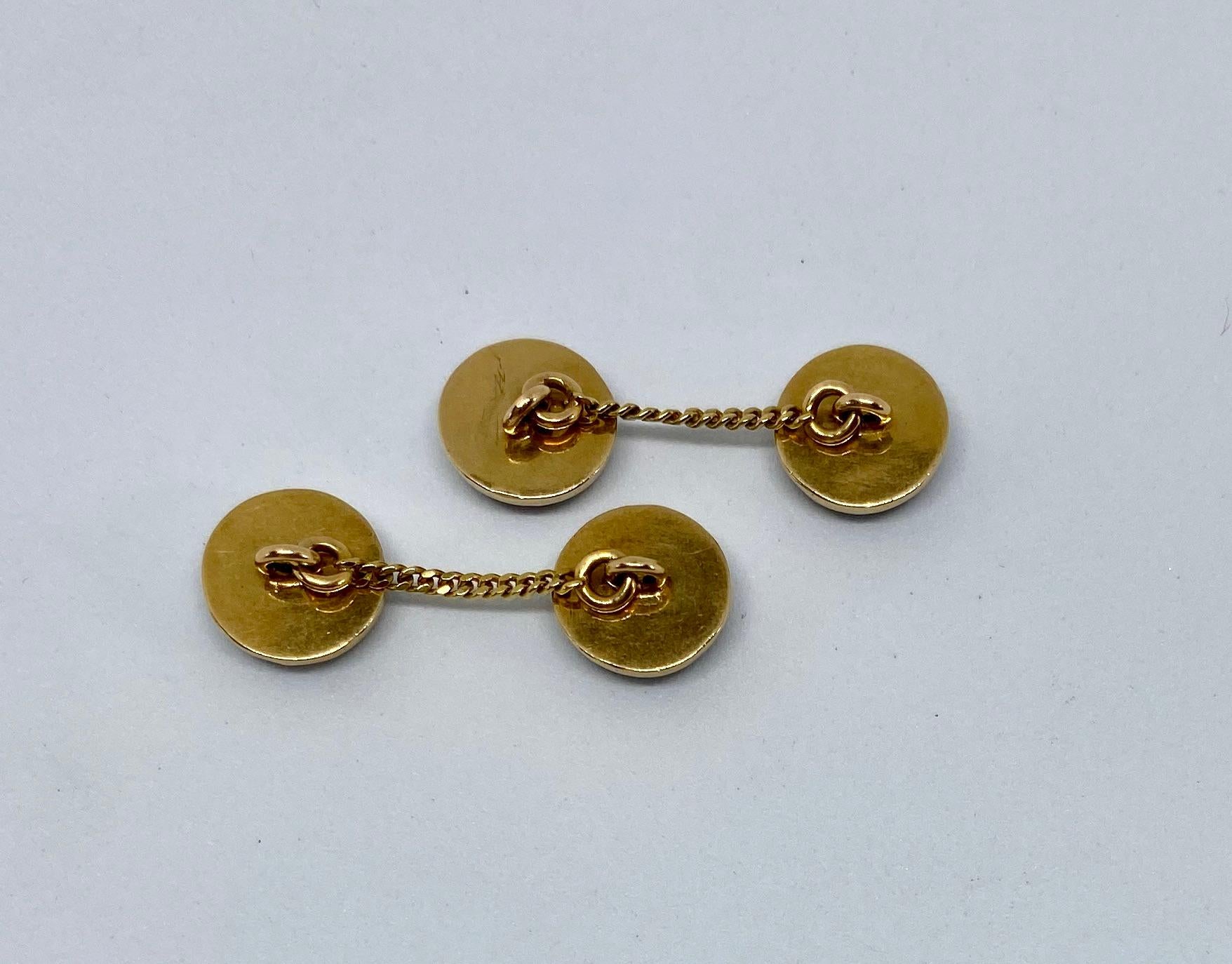 Classic, round hematite cabochons set in 14K yellow gold during the Art Deco period. Curiously, the gold chain connecting each half measures 24.6mm, or about an inch, in length. While these cufflinks work nicely in any standard French shirt cuff,