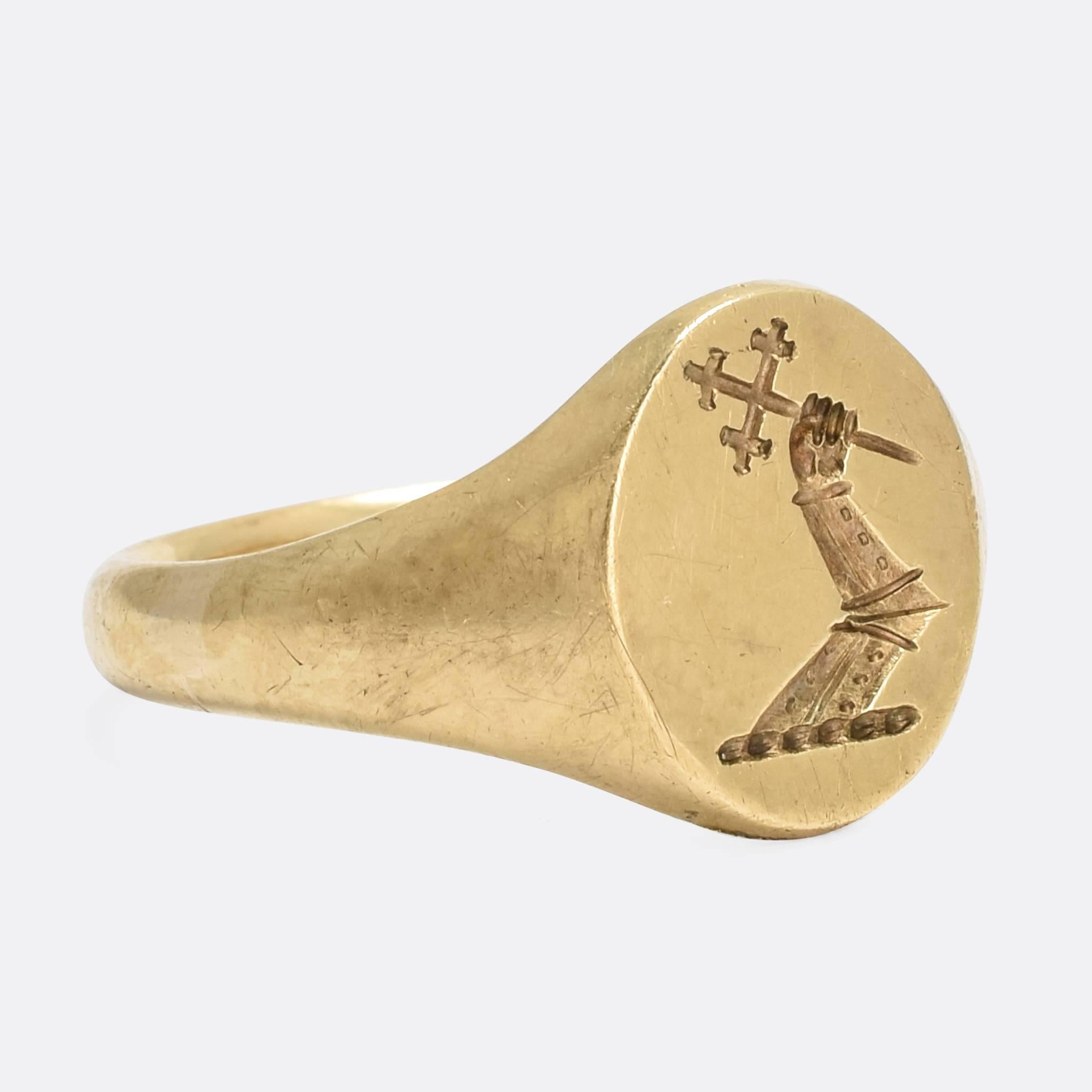 A fine quality vintage signet ring by the esteemed jewellers Deakin & Francis. The face has been carved with an English heraldic crest depicting an Arm - clad in armour - holding a Cross. According to Fairbarn's Book of Crests, this particular seal