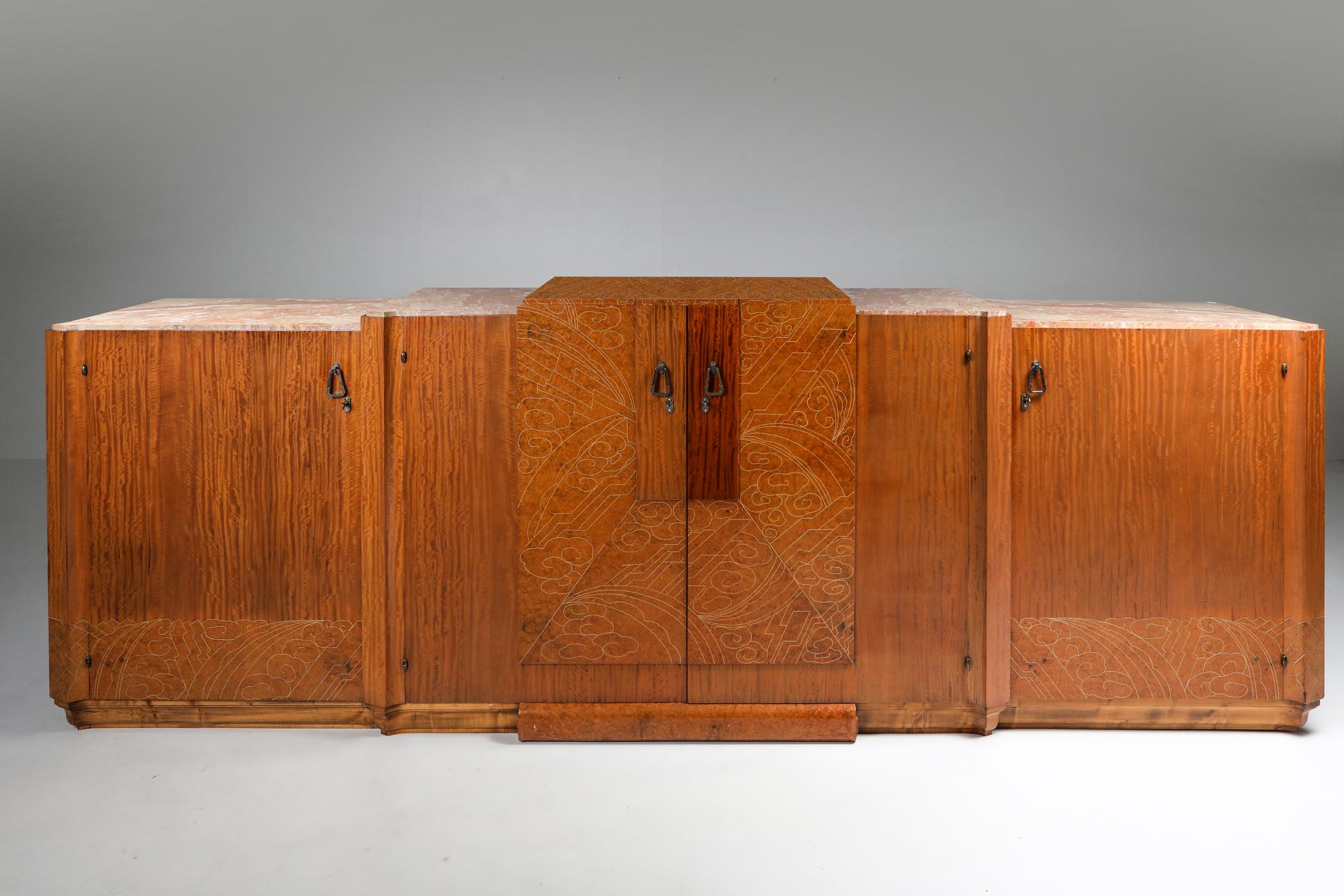 Art Deco sideboard in mahogany, burl, loupe d'amboine and marble, France, 1930s

High-end credenza in a variety of top class materials. The stylish celluloid inlay on the top and door panels display an incredible amount of artistic talent, combined