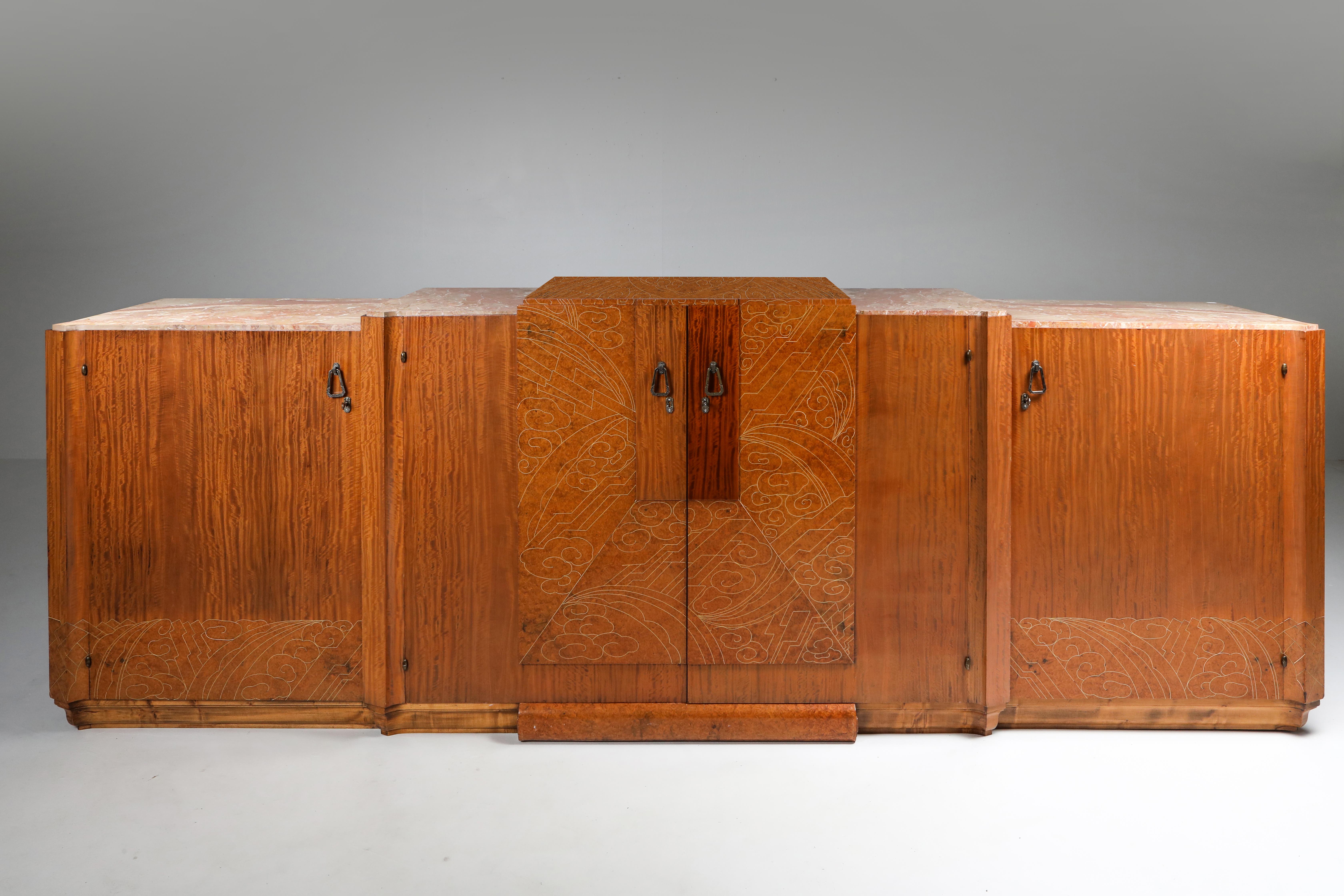 Art Deco sideboard in mahogany, burl, loupe d'amboine and marble, France, 1930s.

High-end credenza in a variety of top class materials. The stylish celluloid inlay on the top and door panels display an incredible amount of artistic talent,