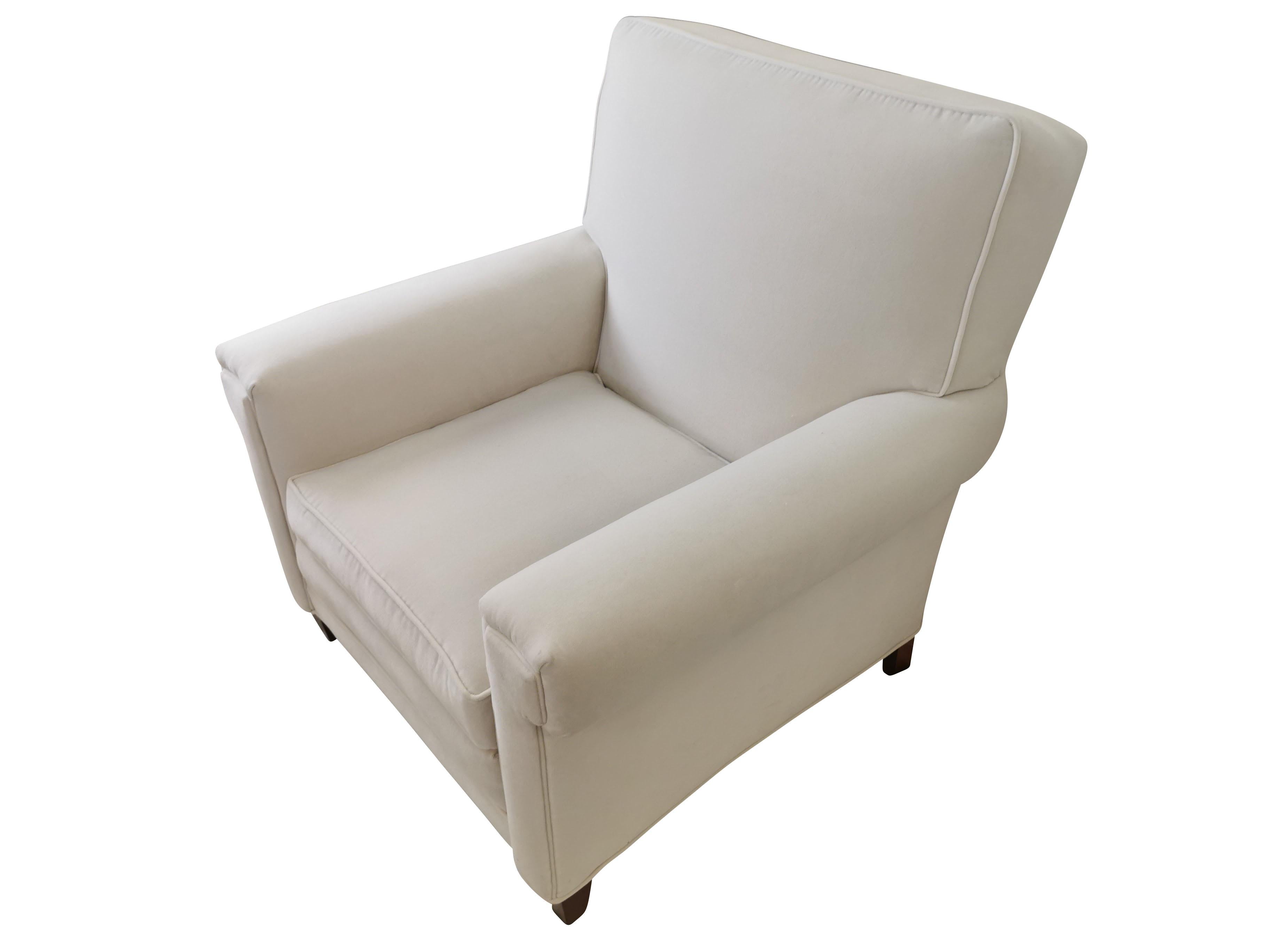 Custom made in the 1940's, these oversized white velvet club chairs were meticulous restored in our Connecticut workroom. They have coil springs in both the seat back and seat cushion. In keeping with the art deco look, we kept the 