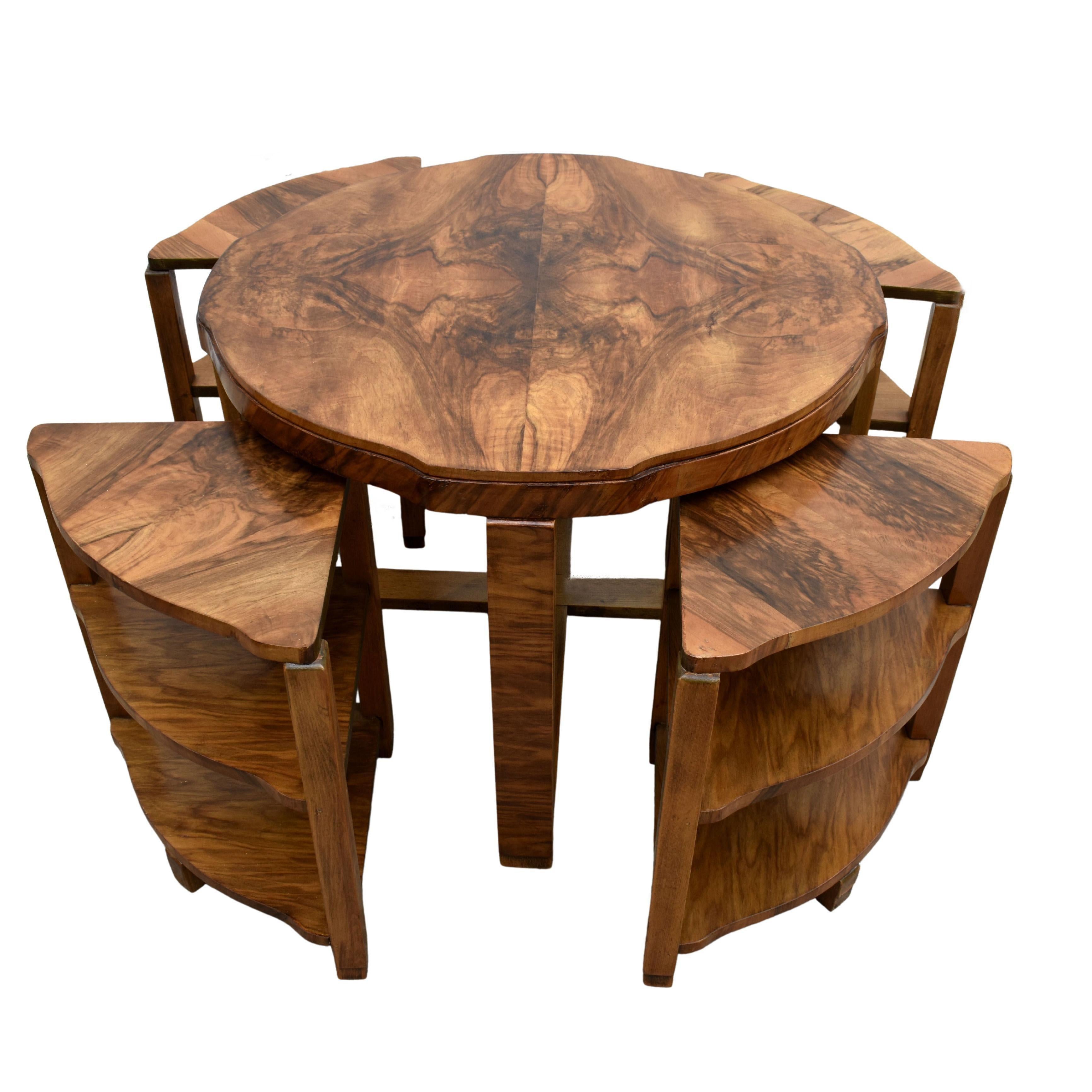This is a beautiful and original 1930's Art Deco set of five tables in Burr Walnut. This gorgeous set comprises one large central circular table with four matching sectional tables that are two tiered that fit very snugly underneath. As you can see