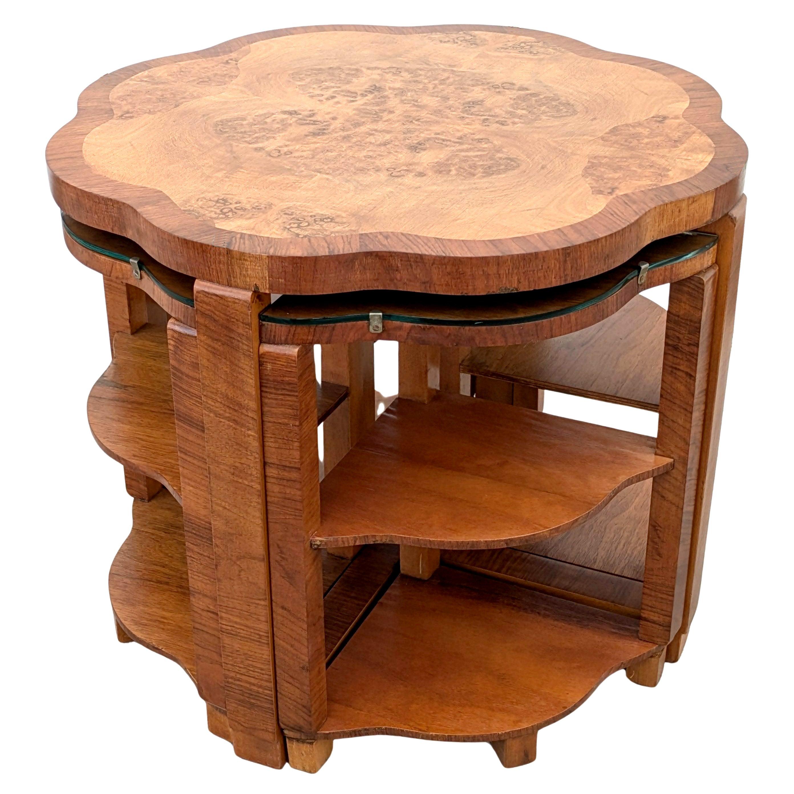 This is a beautiful and original 1930s Art Deco set of five tables in Walnut . This gorgeous set comprises one large central circular table with four matching sectional tables that are two tiered that fit very snugly underneath. As you can see from