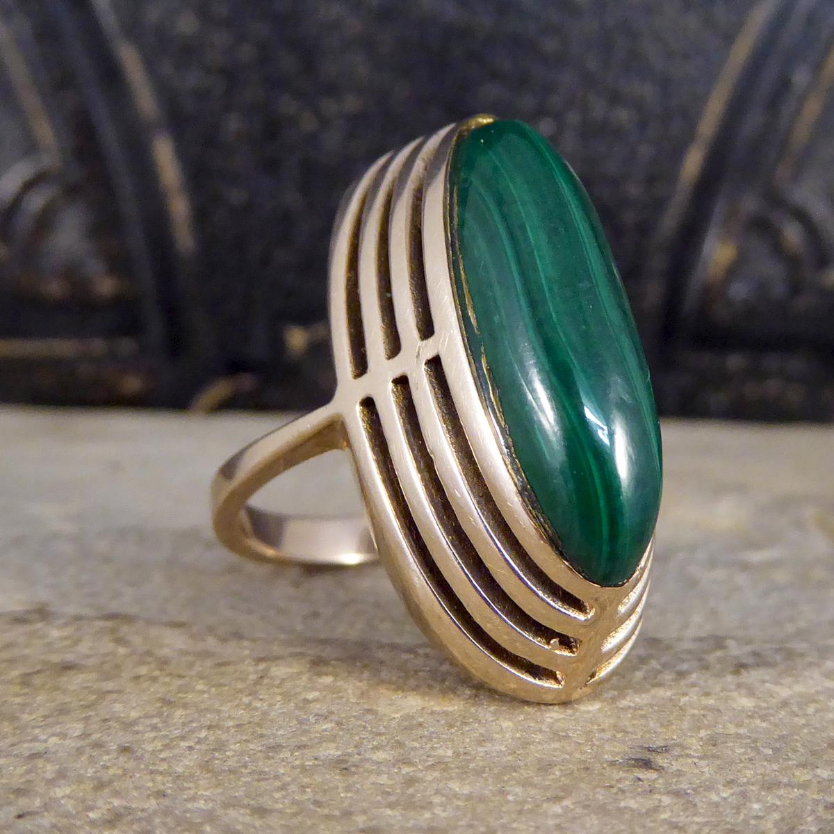This lovely little ring has been crafted in the Art Deco era with marks of 9ct stamped on the inner band. Featuring a high set mesmerising Malachite gemstone in the centre of the ring with a 9ct Yellow Gold layer detailing around. A gorgeous stand