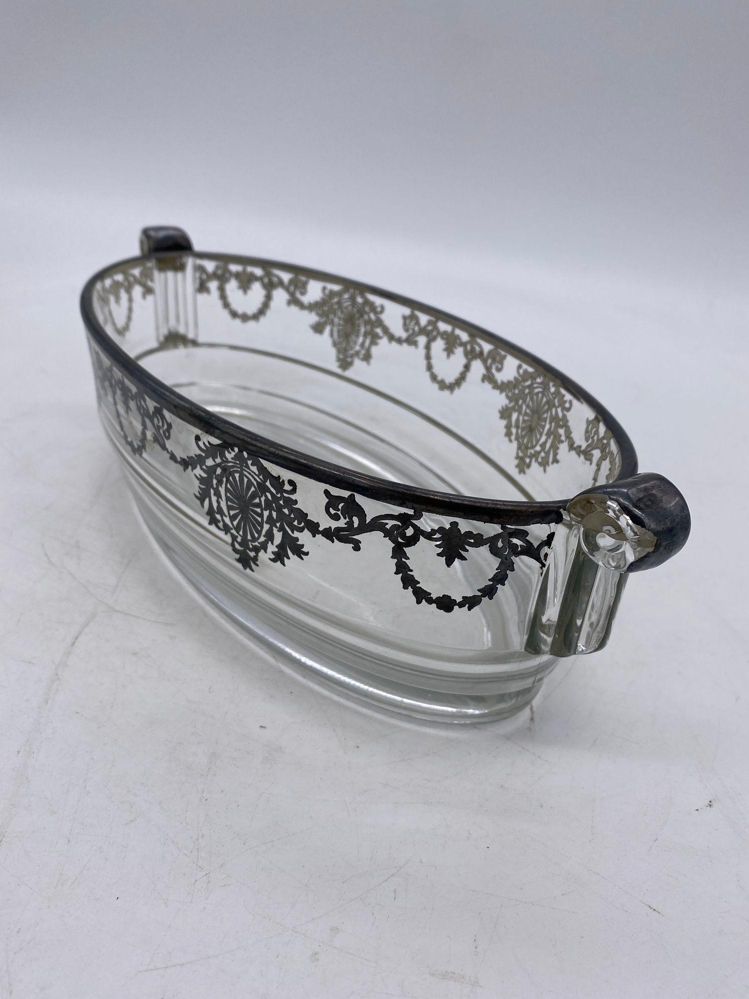 High Style glass serving bowl with sterling silver Overlay/Inlay and scrolling handles and Art Deco shape.

Circa 1920