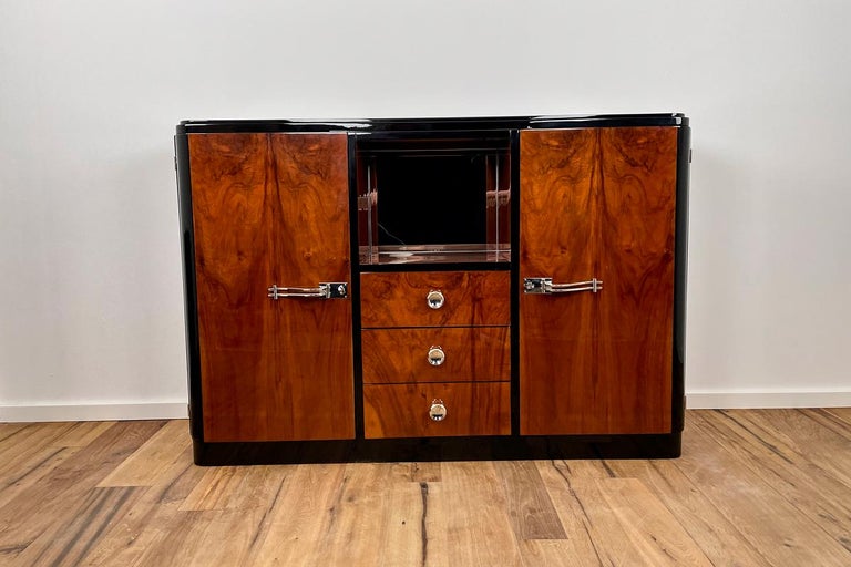 Art Deco highboard with a fantastic veneer and mirrored compartment, the original handles have been newly chrome-plated
We were able to acquire this wonderful piece of furniture from an industrial loft in Hamburg (the owner had to sell 2 Art Deco