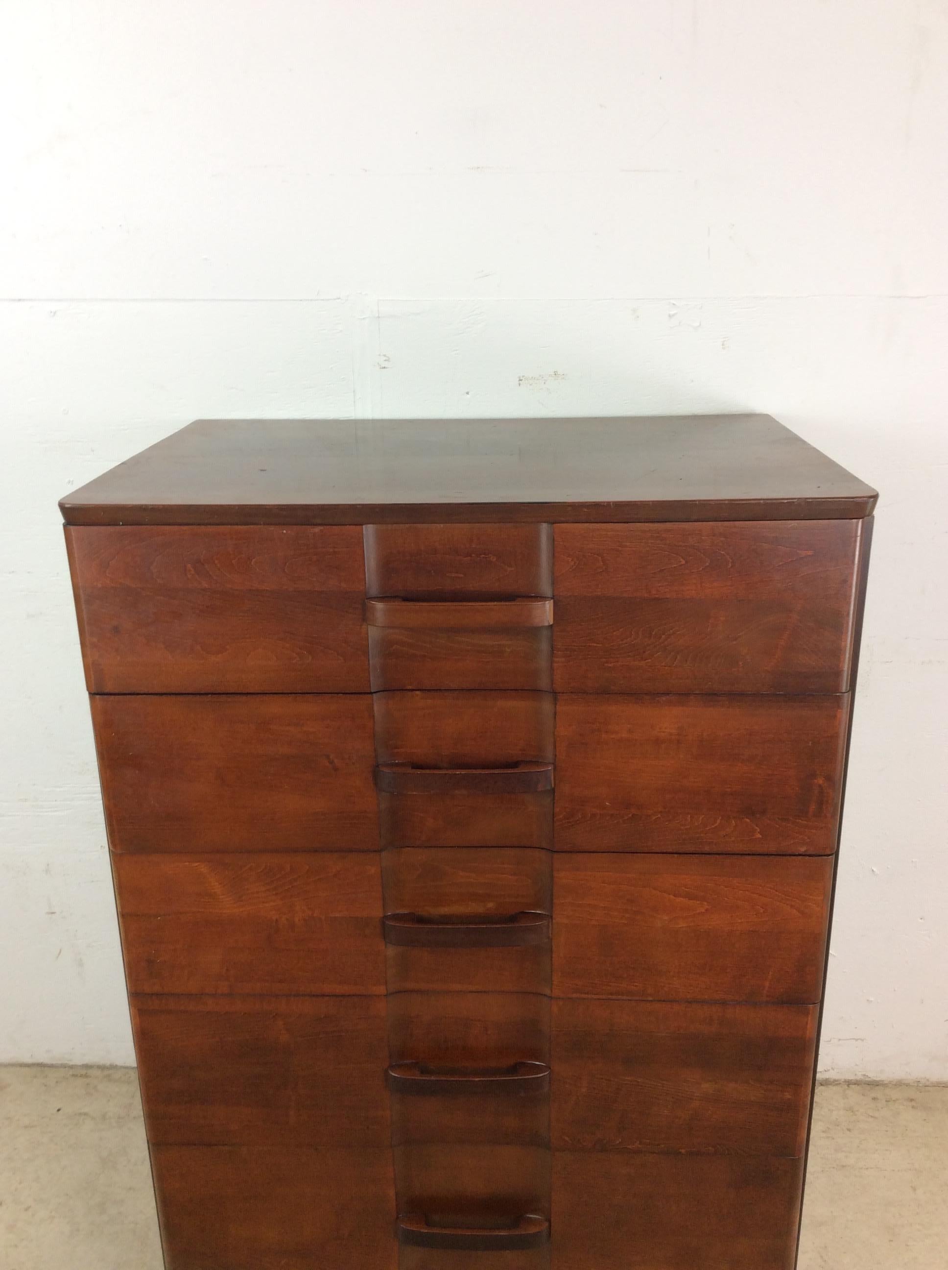 This Art Deco highboy dresser features hardwood construction, original mahogany finish, five dovetailed drawers with wooden pulls and stubby block feet.

Dimensions: 30w 20.5d 42.25h 

Condition notes: Original finish is in good condition with