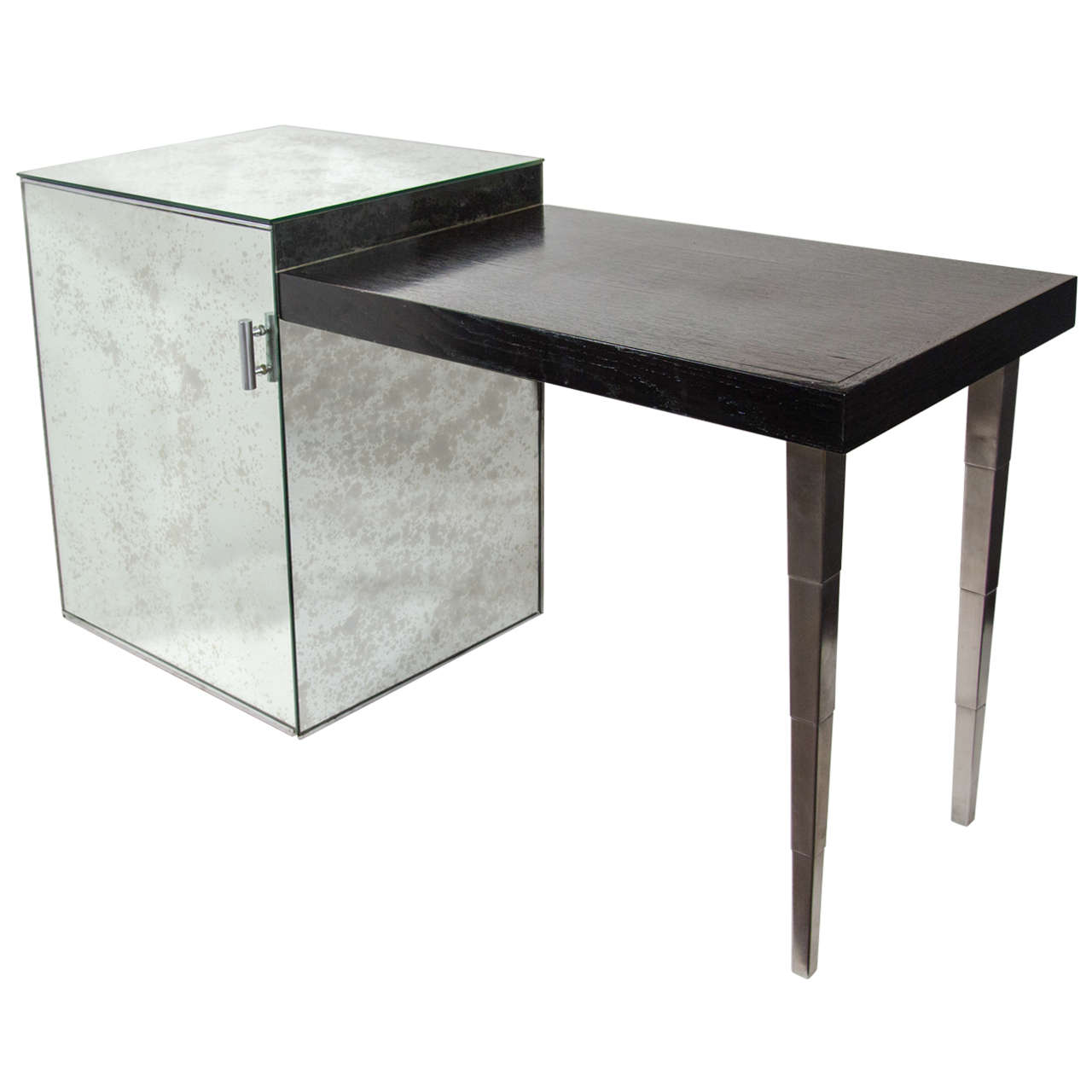 Elegant Art Deco writing table and vanity comprised of an ebonized walnut wood tabletop with an antique mirrored cabinet. The cabinet features smoked and spotted glass mirrors and has silver leaf painted interior. Features brushed nickeled support