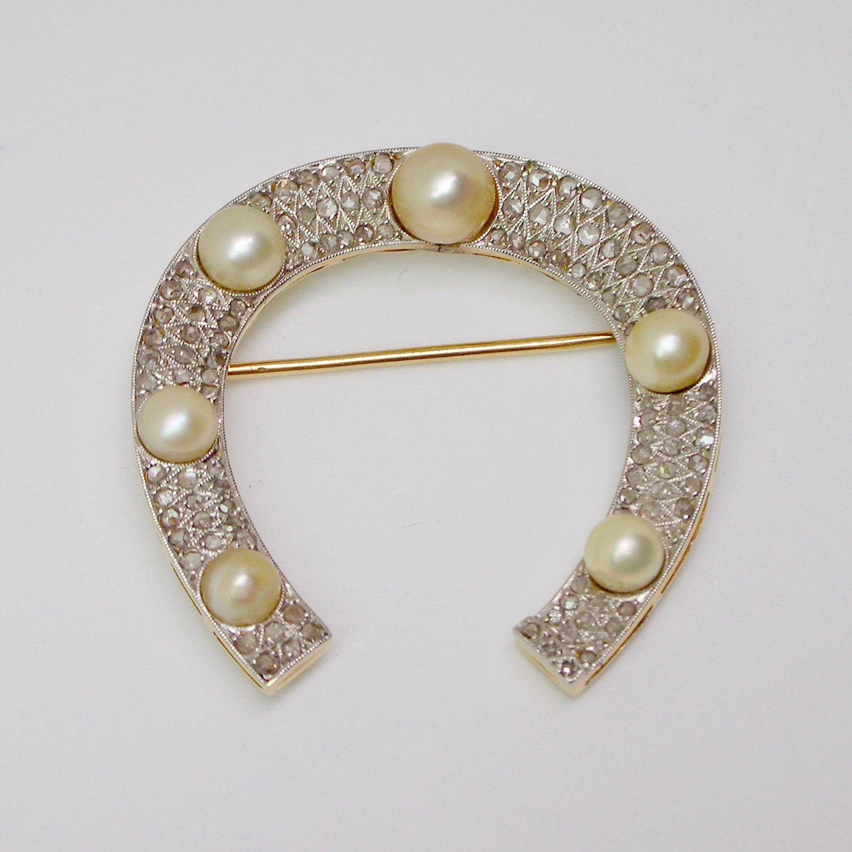 This beautiful horseshoe shaped brooch is set in gold and platinum with rose cut diamonds and cultured pearls. Most likely from the 1920 / 30s.