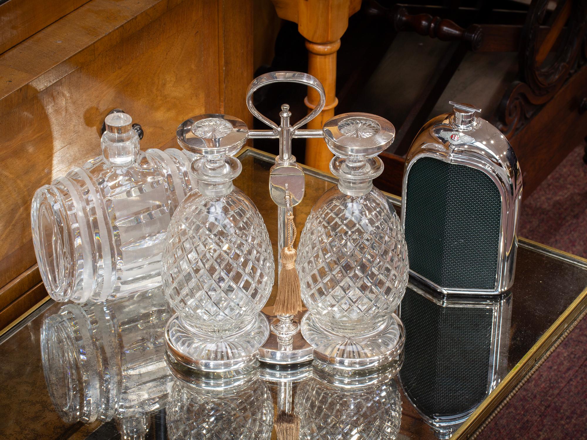 Art Deco Circa 1920

From our Tantalus collection, we are delighted to offer this Art Deco Silver Plate Tantalus by Hukin and Heath. The Tantalus modelled with two quilt-cut pineapple shaped decanters locked into place by a silver plate frame. The
