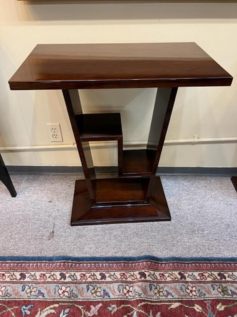 Console is smaller size, very convenient and easy to fit. Made out of walnut wood. Composed out of console top and 2 thin wide legs that are connected with rectangular base. Between there is “Z” decorative element that could be used as a small