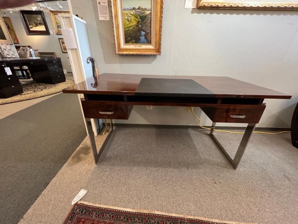 Desk top is made out of high police walnut wood with cowhide insert in the middle. There are 2 drawers with chrome handles. Desk is elevated by thin chrome legs that are connected on each side. 

Condition is perfect, restored
Hungary,