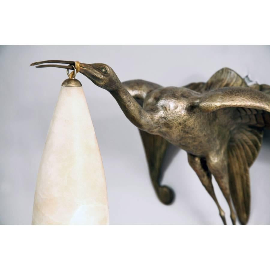 A pair of rare Art Deco silvered bronze sconces casted in the form of Ibis with spreading wings, carrying in it's beak a conical alabaster shade that illuminates; signed Albert Cheuret.
Made in France
circa 1925.