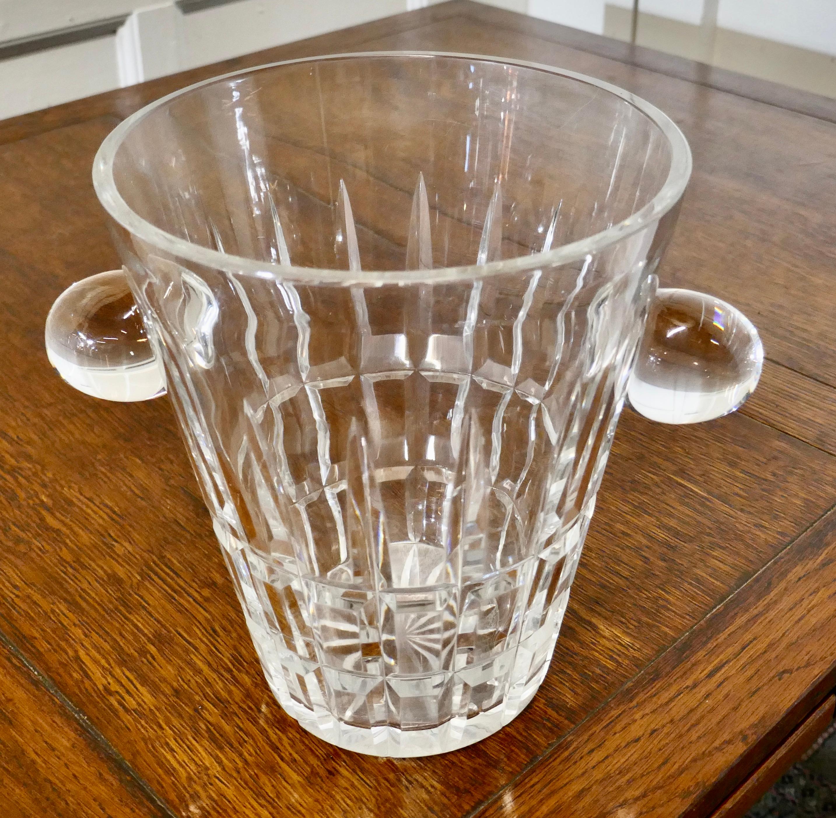 Art Deco ice bucket, hand cut French crystal wine cooler

A very stylish piece with straight elegant lines, sweeping outward at the top with chunky knob handles 

The cooler or Ice Bucket is extremely heavy, it has some scratching to the
