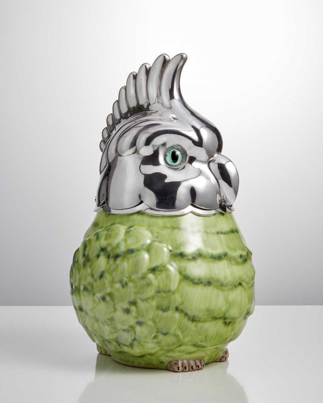 Art Deco Barware Ice Bucket in the Form of a Parakeet, Austria, circa 1930

This is a very unusual Barware item and well made not only the head but also the plated lower rim section, where when closing the lid gives it a cushion effect.
 The ceramic