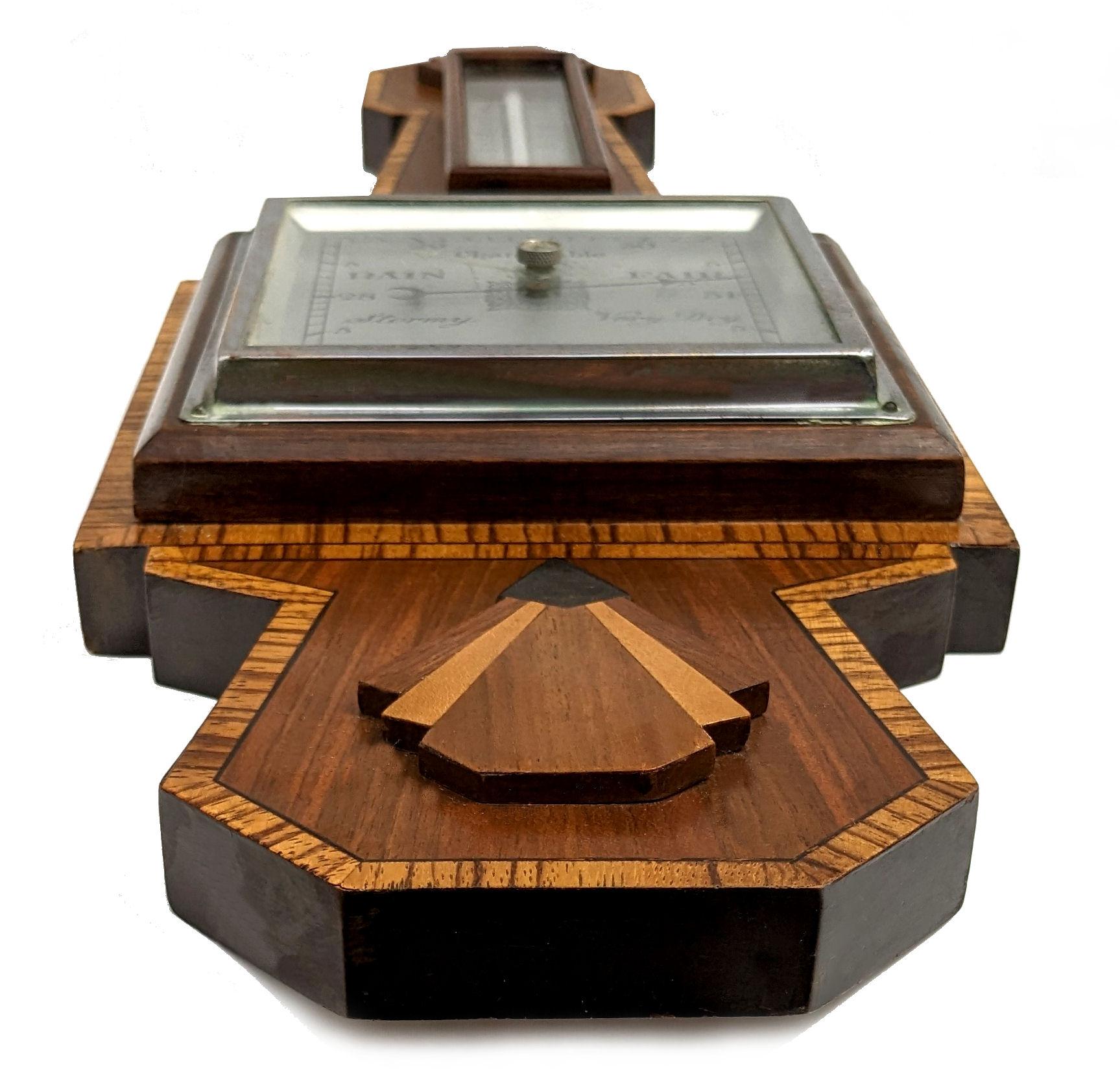 If you're looking for something a little different then look no further than this superbly styled Art Deco Barometer / Aneroid Thermometer. Features the most fabulous woodworking inlay marquetry. The whole shape with fan detailing screams Art Deco.