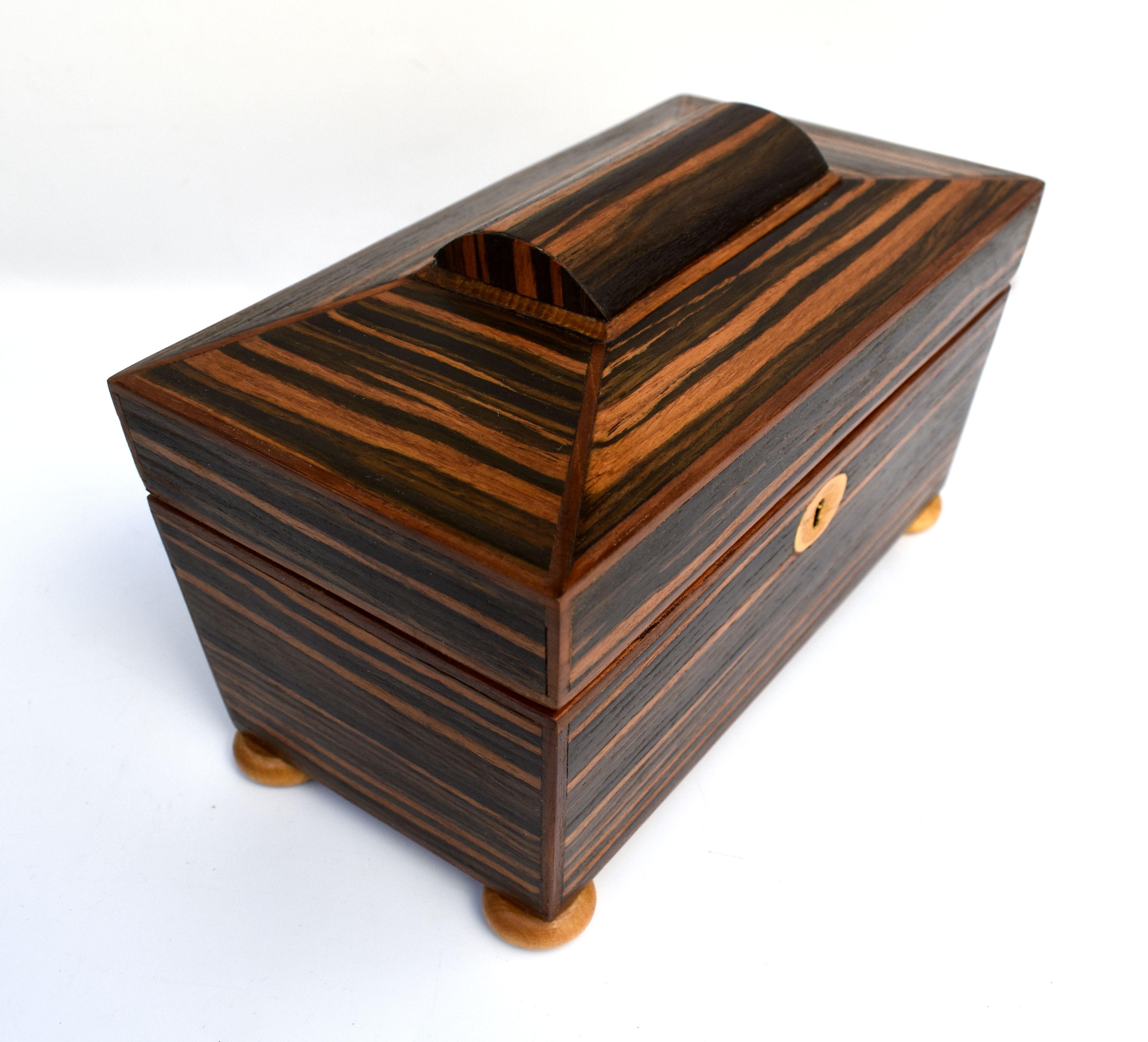 For your consideration is this superbly iconic looking Art Deco wooden box which we think was a tea caddy or for cigarettes originally. The exterior of the box is veneered in a beautiful ebony Macassar. The interior is an absolute marvel of surprise