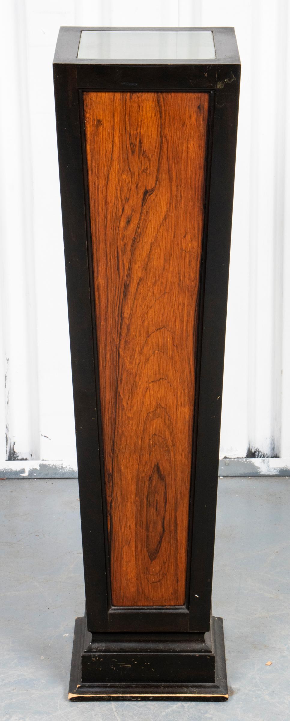 Art Deco illuminated parcel ebonized pedestal with interior bulb for surface lighting. Measures: 38.75
