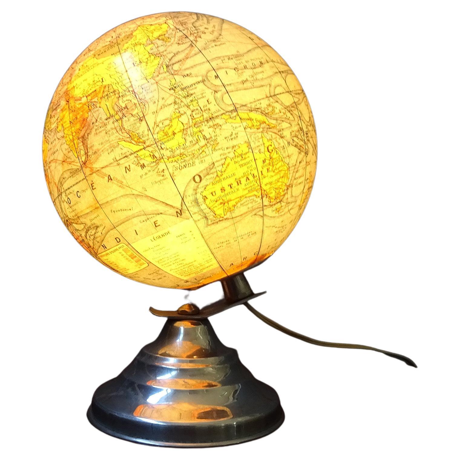 French globe by Girard Barrère & Thomas. This small glowing glass globe was made before 1948. Typical Art Deco design on a step-shaped base made of aluminum and a globe made of glass.