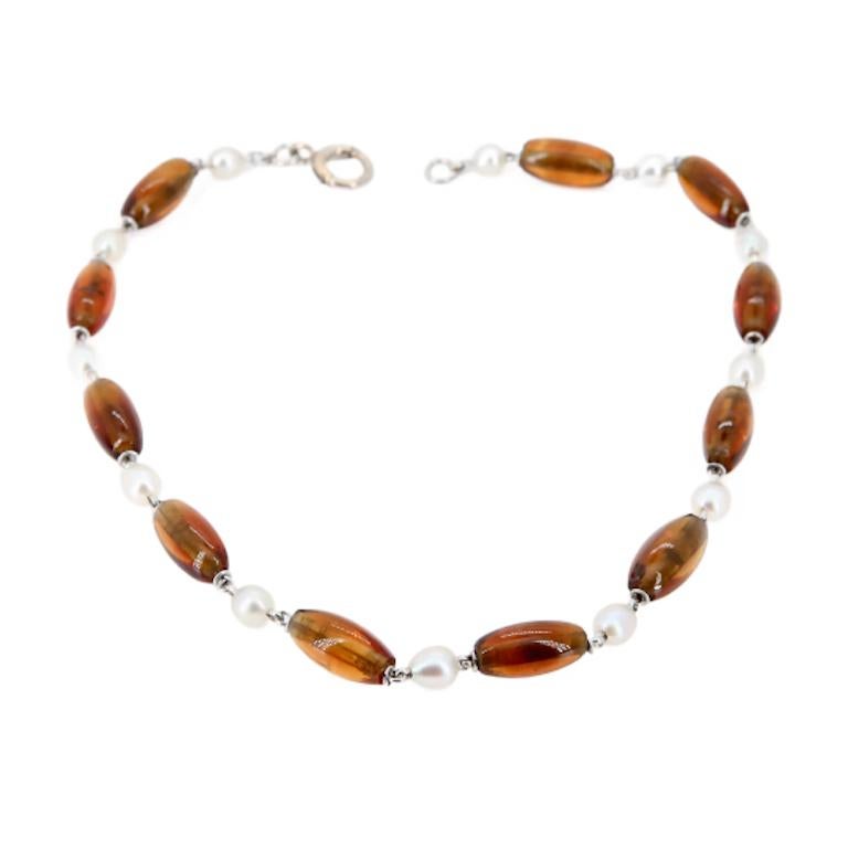 Aston Estate Jewelry Presents:

An Imperial Topaz, and natural saltwater pearl bracelet in platinum.  Comprised of alternating elongated tapered amber bead links, spaced with natural 3mm diameter saltwater pearls.

Hallmarked as Platinum on the