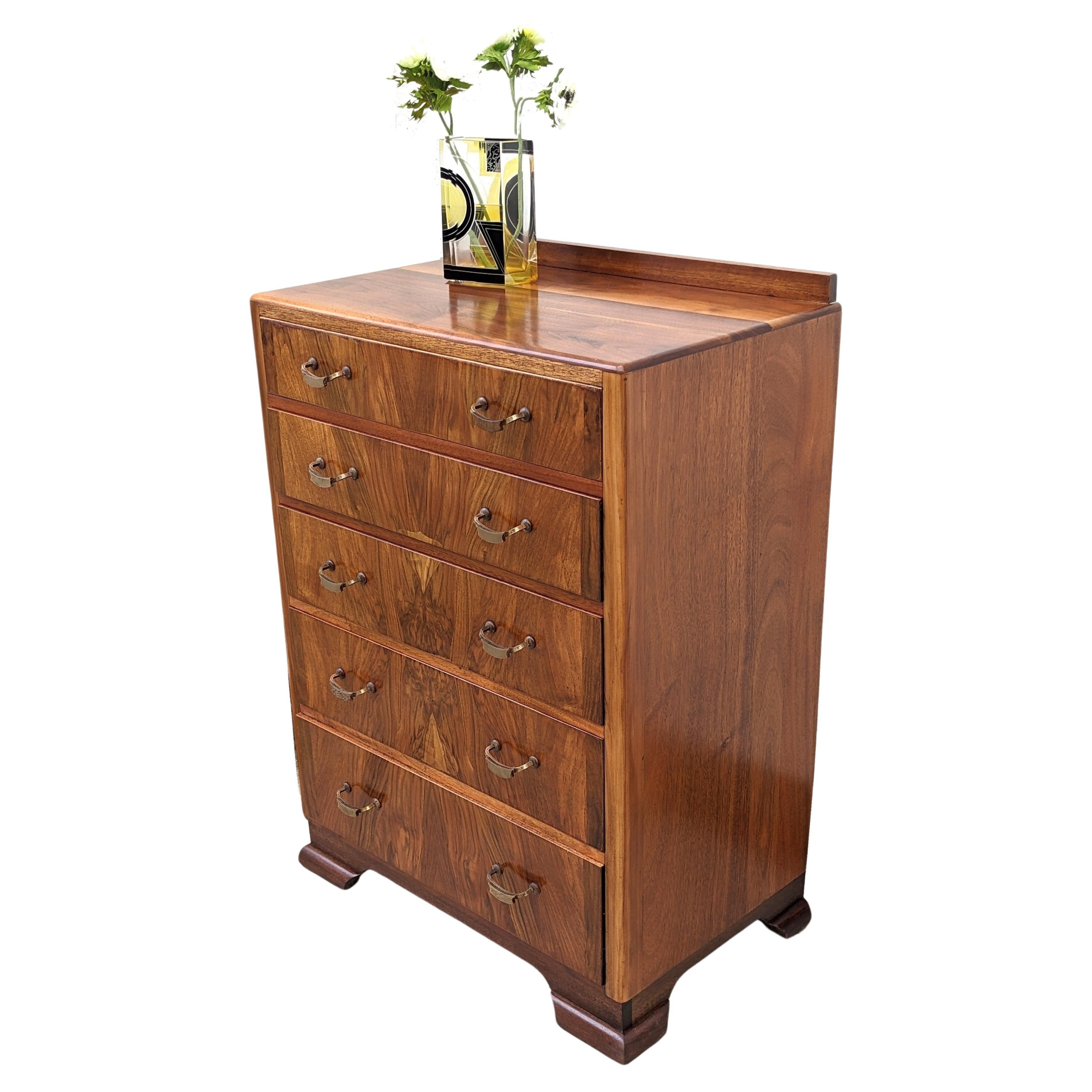 For your consideration is this very stylish and beautifully figured Walnut original Art Deco chest of drawers which dates to the 1930's. Five generously sized drawers which are veneered in a warm mid tone figured walnut veneer with original bakelite