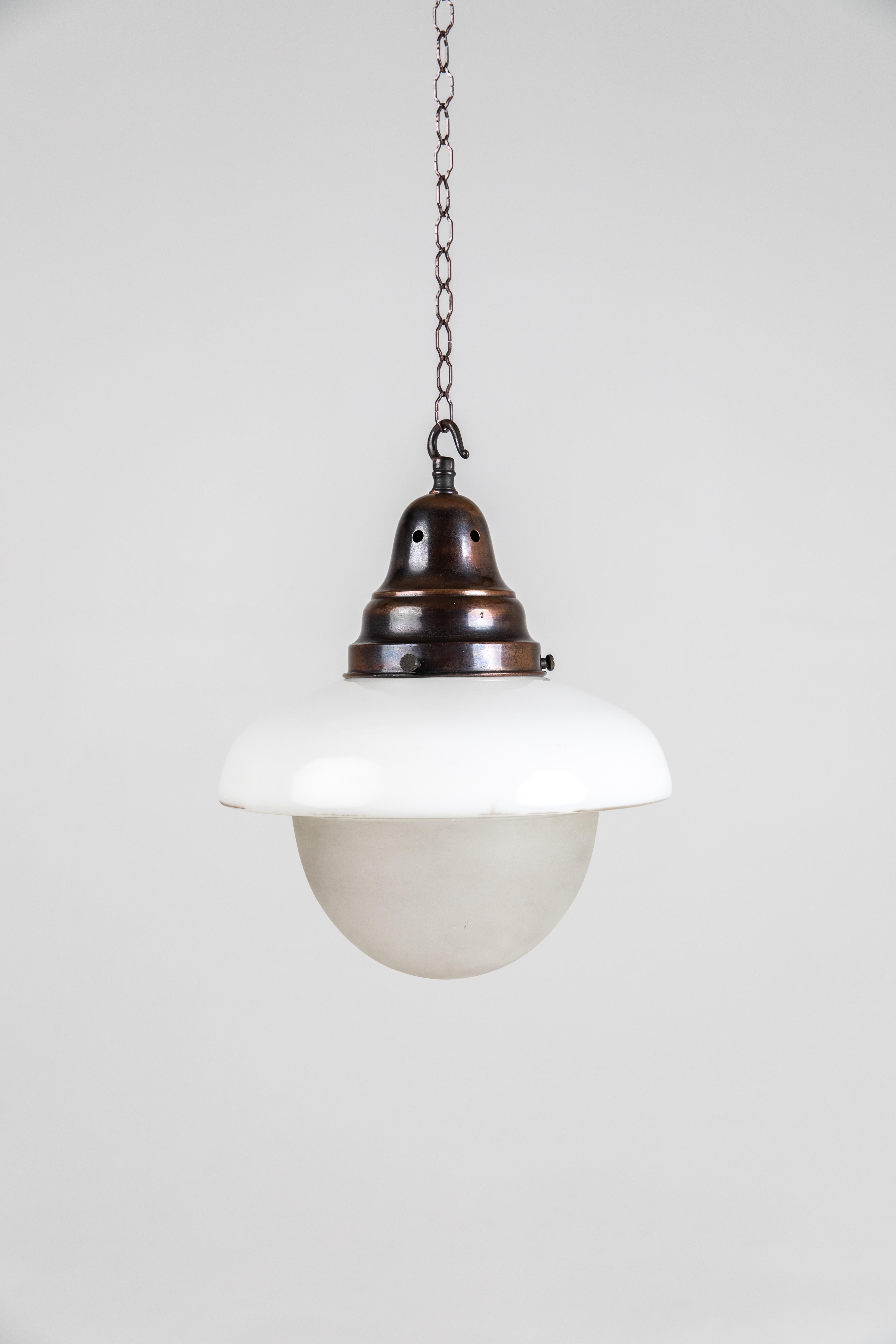 Beautiful acorn shaped three tone opaline pendants made in England by GEC - General Electric Company. c.1930

A wonderfully shaped light with frost bowl beneath clear and opaline sections above. Period copper galleries. Price is per