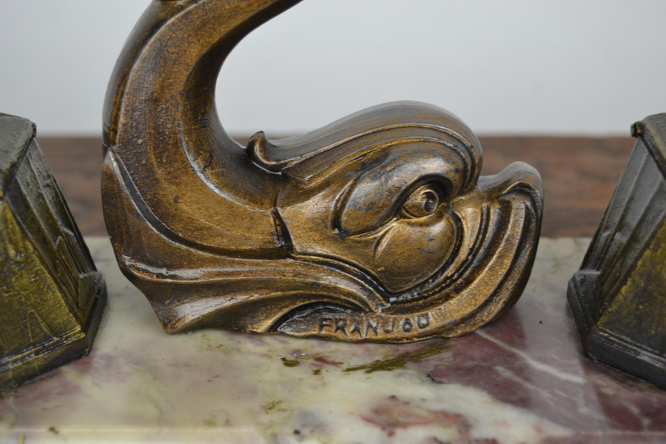 Art Deco inkwell with a fish by the French Artist Franjou.
This desk ornament has a bronze patinated metal dolphin fish with two ink reservoir mounted on Venous marble base. The glass inkwells are no longer in the reservoirs. The fish sculpture is