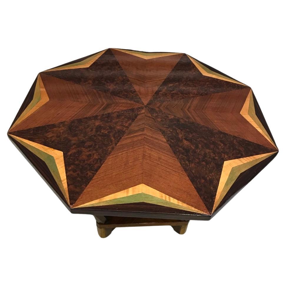Art Deco inlaid walnut coffee table. Octagonal in outline. The top is a wonderful geometric pattern featuring alternating straight and burr walnut, beautifully accented with paler veneers , one of which has the slightest hint of green to it. This is