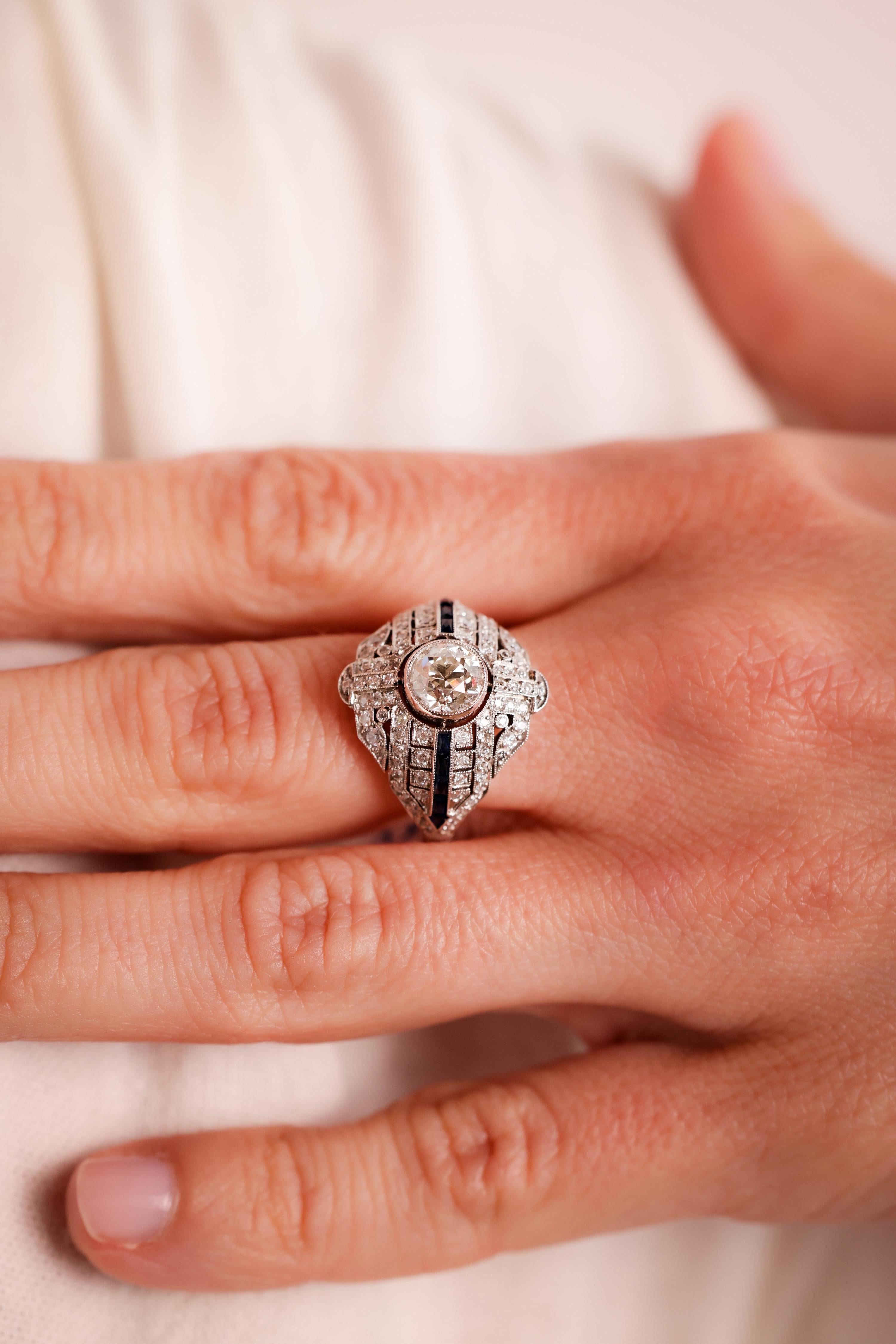 Center Stone: Diamond
Cut: Old European
Weight: 1 Carat
Color: L
Clarity: SI
Accent Stone: 92 Diamonds
Cut: Old Mine and Old European Cuts
Weight: Approximately 0.8 Carats
Color: H
Clarity: SI
Metal: Platinum
Era: Modern
Circa: 2020's in the Style