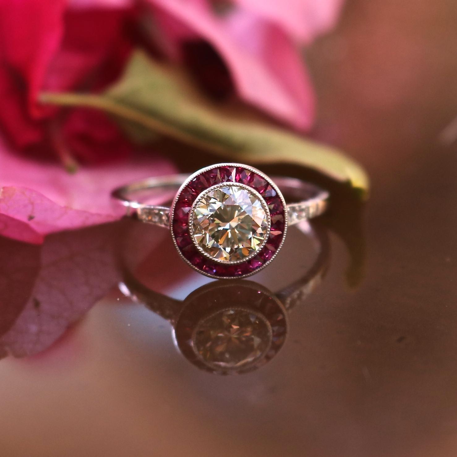 Surrounded by lustrous rubies, the 1.12 carat golden light brown diamond shimmers in a halo of love. Inspired by Art Deco elegance this beauty is made by a master craftsman specializing in the era. Using designs and techniques of the time, our Deco