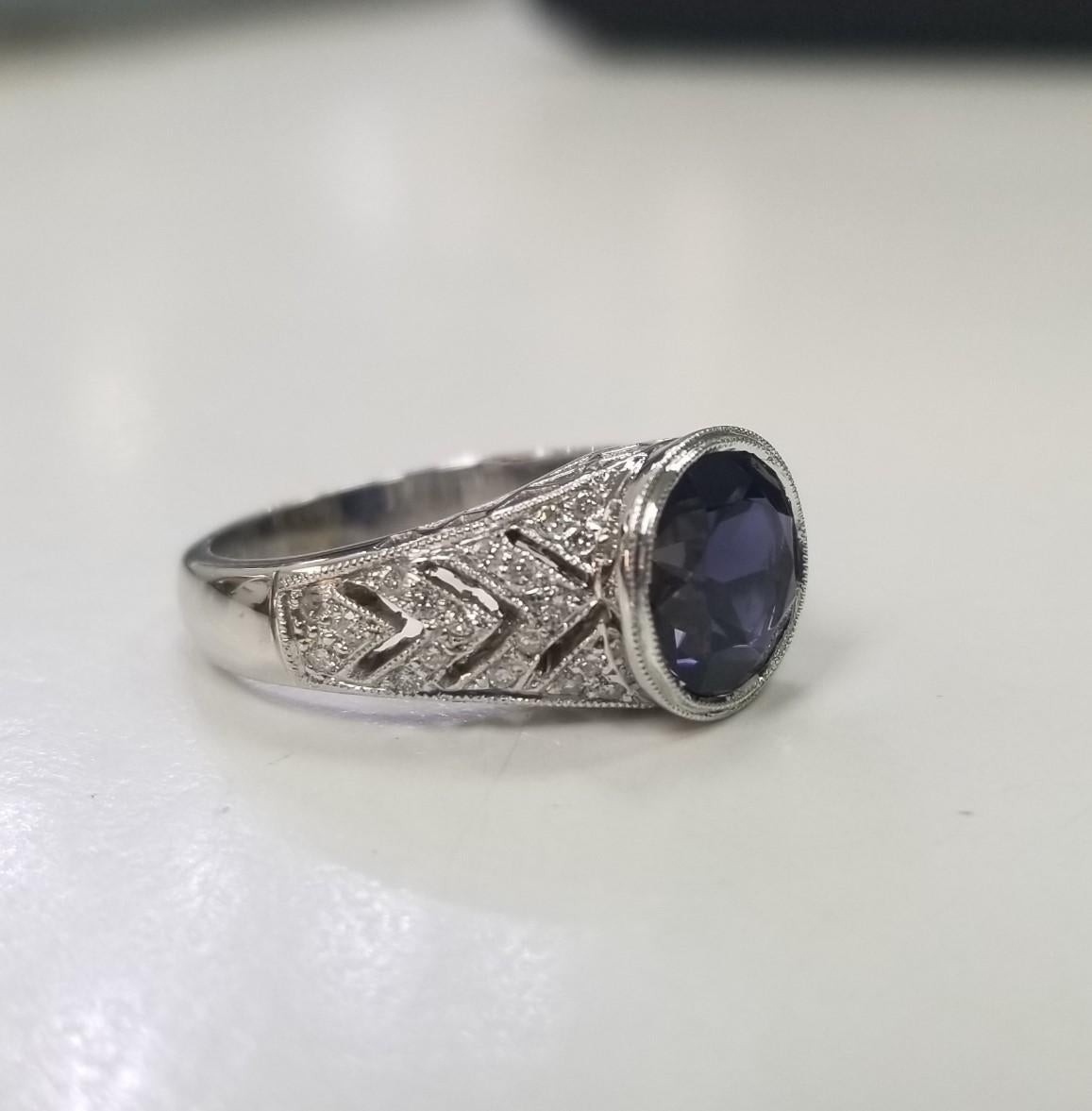 14k white gold Iolite and diamond ring, containing 1 round Iolite of gem quality weighing 2.47cts. and 38 round full cut diamonds weighing .28pts.  This ring is a size 6.5 but we will size to fit for free.