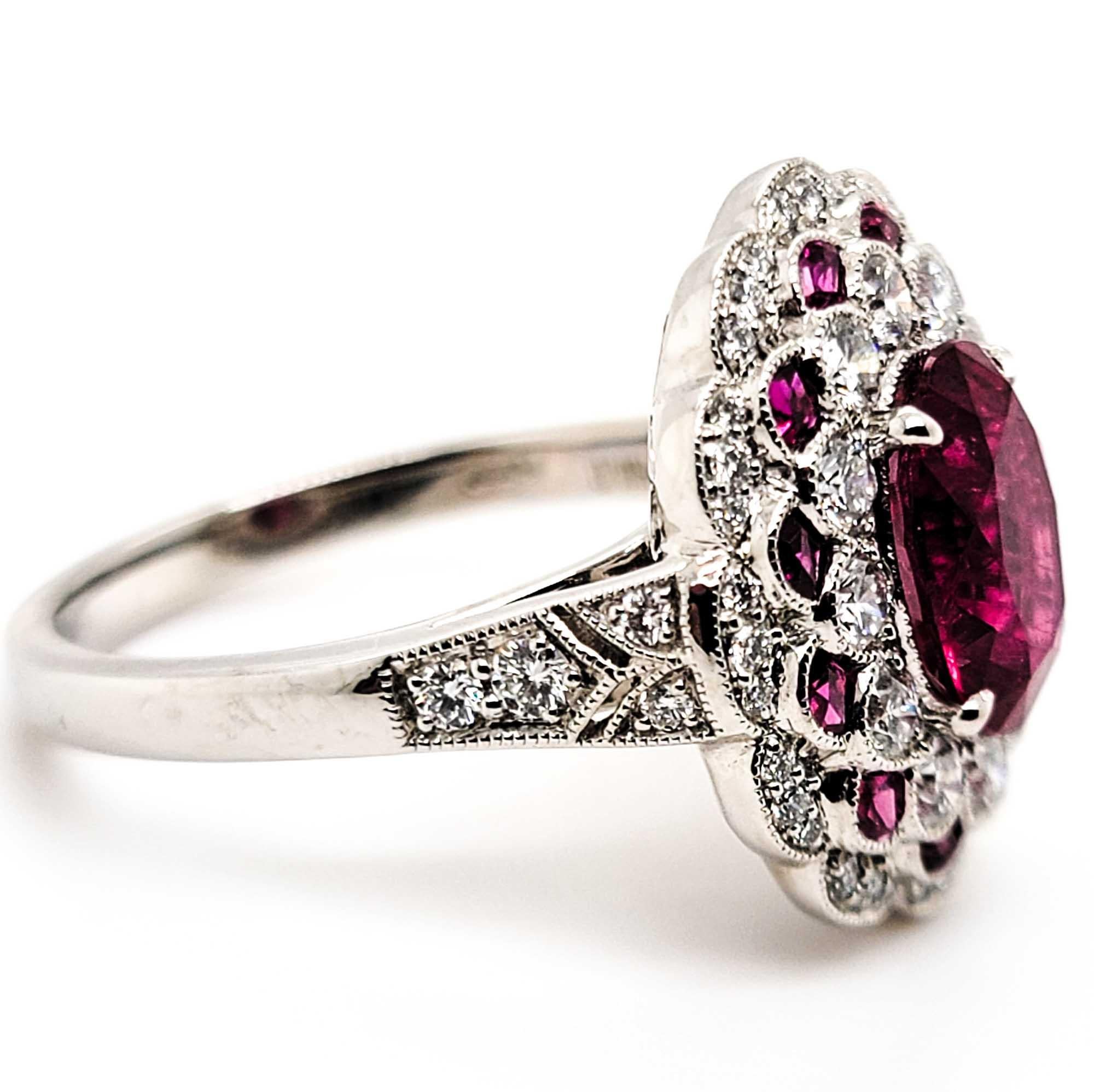 Art deco inspired oval cut shape ruby center ring set in platinum with the total weight of the center ruby 1.88 carats surrounded by stunning small rubies weighing 0.35 carat along with diamonds weighing a total of 0.68 carats.

Sophia D by Joseph